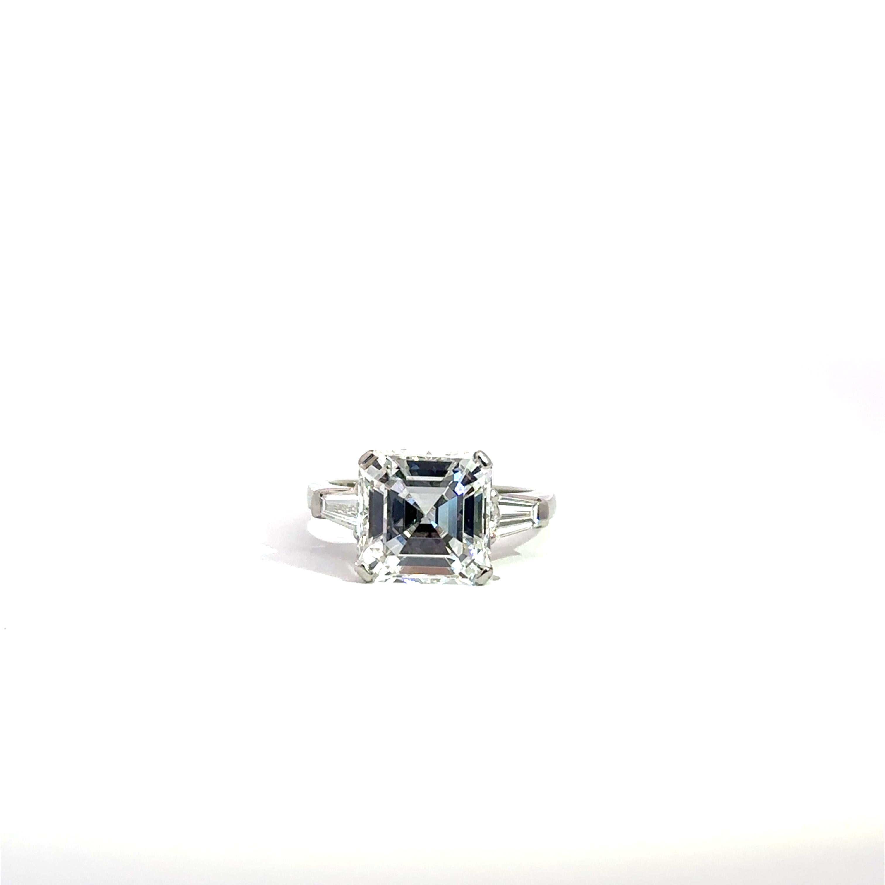 GIA Cert.#12721578 
5.21 carats, white emerald cut diamond 
Measurements 9.94 x 9.92 x 6.45mm
2-White Baguette cut diamonds 0.52cts.
Color Grade is D 
Clarity Grade is IF
Proportions Depth 65% Table  57%
Girdle Medium, Polish
Finish. Polish Very