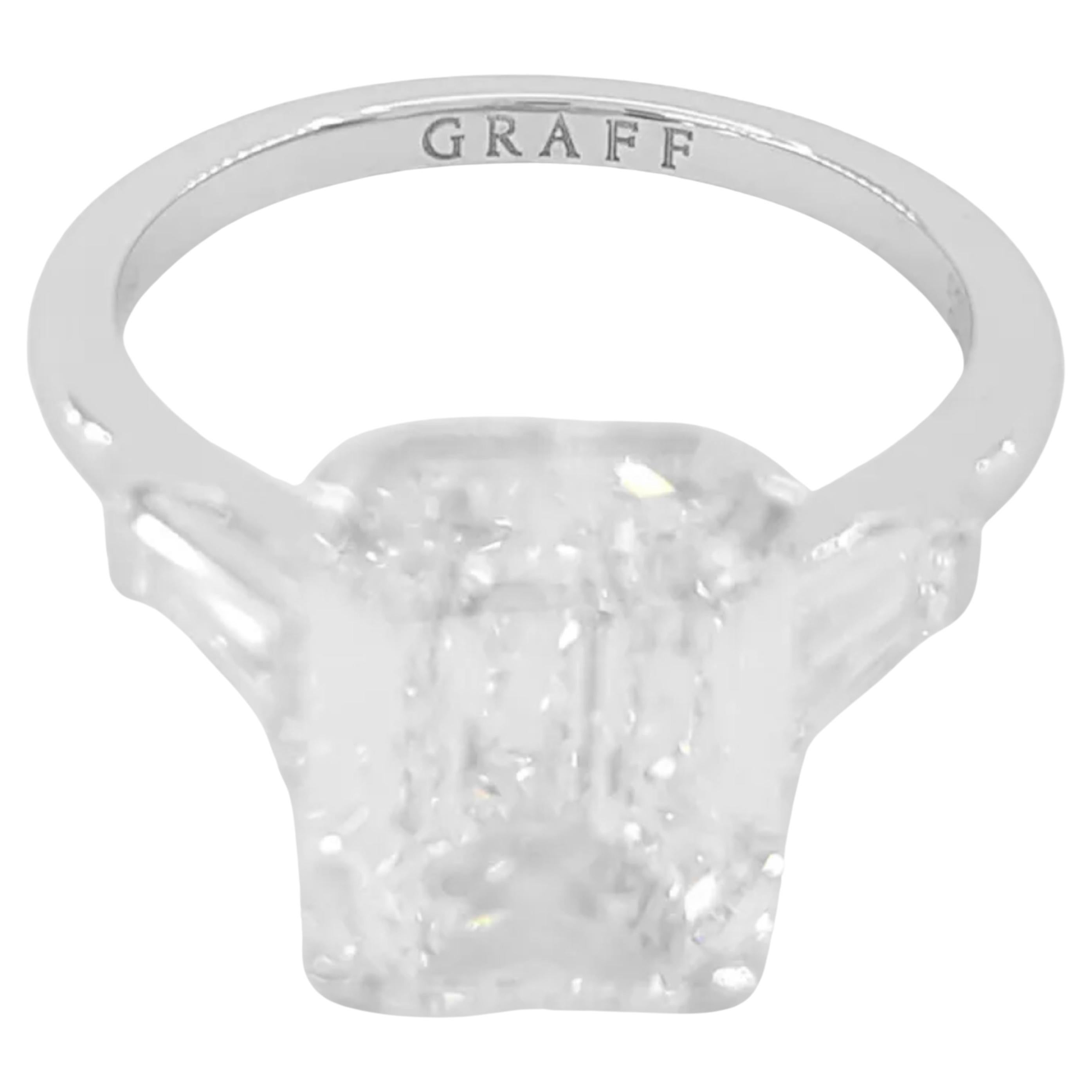 stunning Graff Three-Stone Promise Engagement Ring, featuring a total weight of 5.91 ct with Emerald Cut and Tapered Baguette Cut Diamonds, elegantly set in platinum.

This exquisite ring weighs 5.9 grams and is a size 6.5. The centerpiece is a