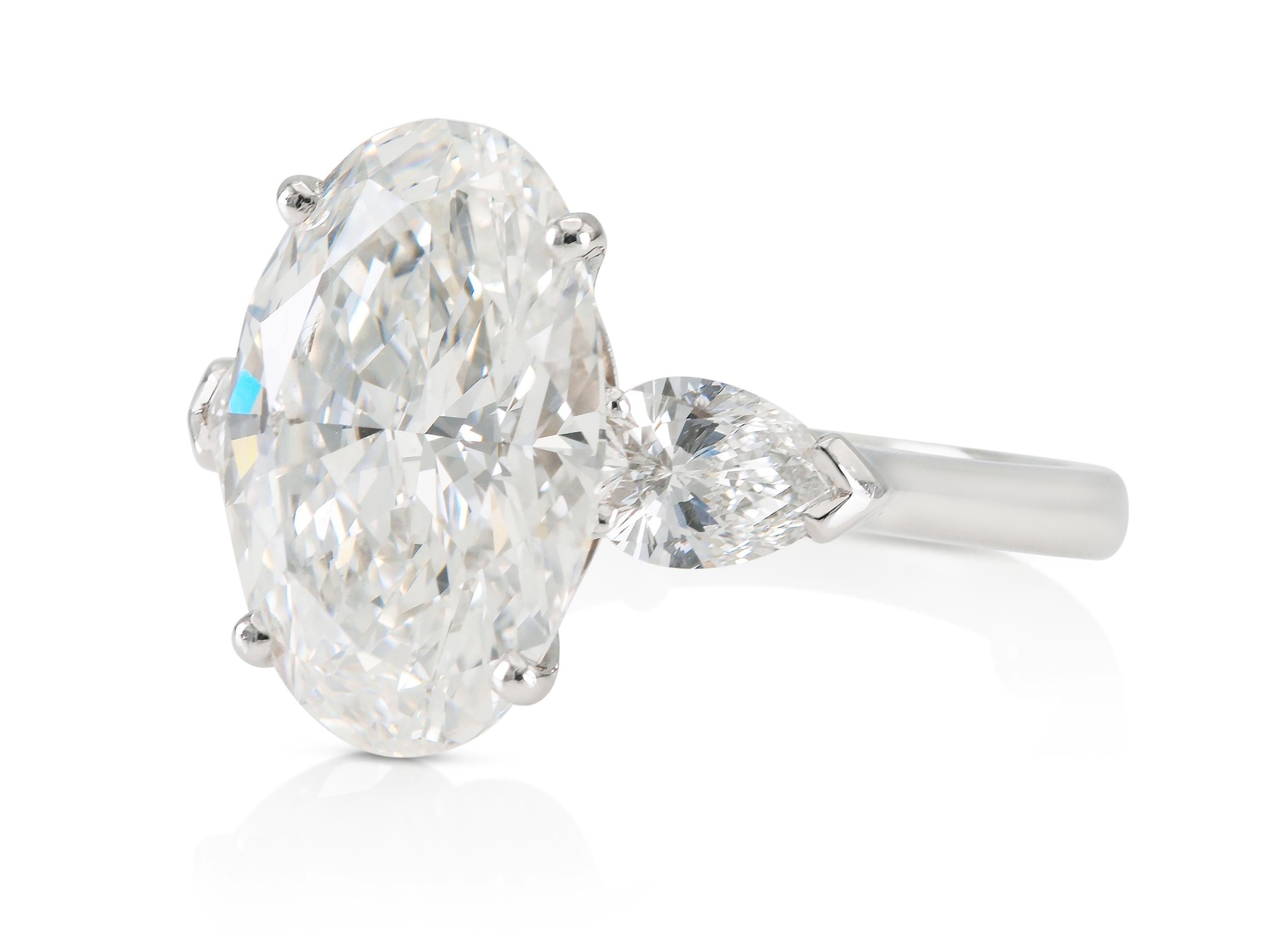 Finely crafted in platinum with a GIA certified Oval cut Diamond, H color, VS2 clarity, GIA #15224696.
The ring features 2 Pear-Shaped side Diamonds weighing a total of 1.08 carats.
Signed by Graff
Size 7
Comes with its Certificate of Quality from