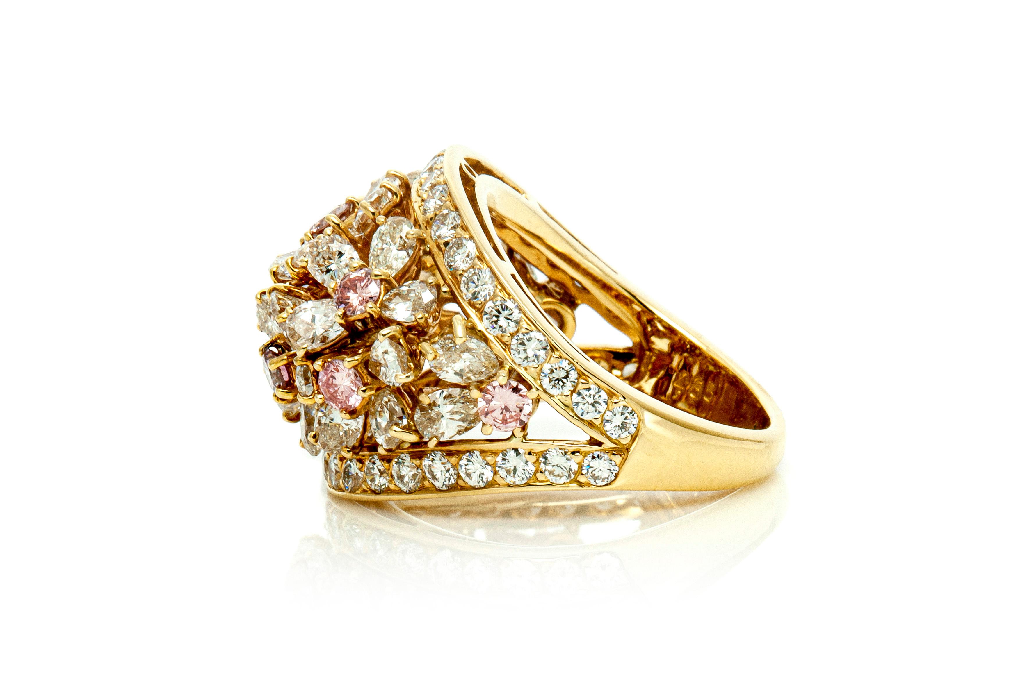 Finely crafted in 18k yellow gold with flowers made out of pear cut white diamonds and round cut pink diamonds.
The ring features round brilliant cut diamonds as framing for the flowers.
The diamonds on the ring weigh a total of 4.85 carats.
Sign by