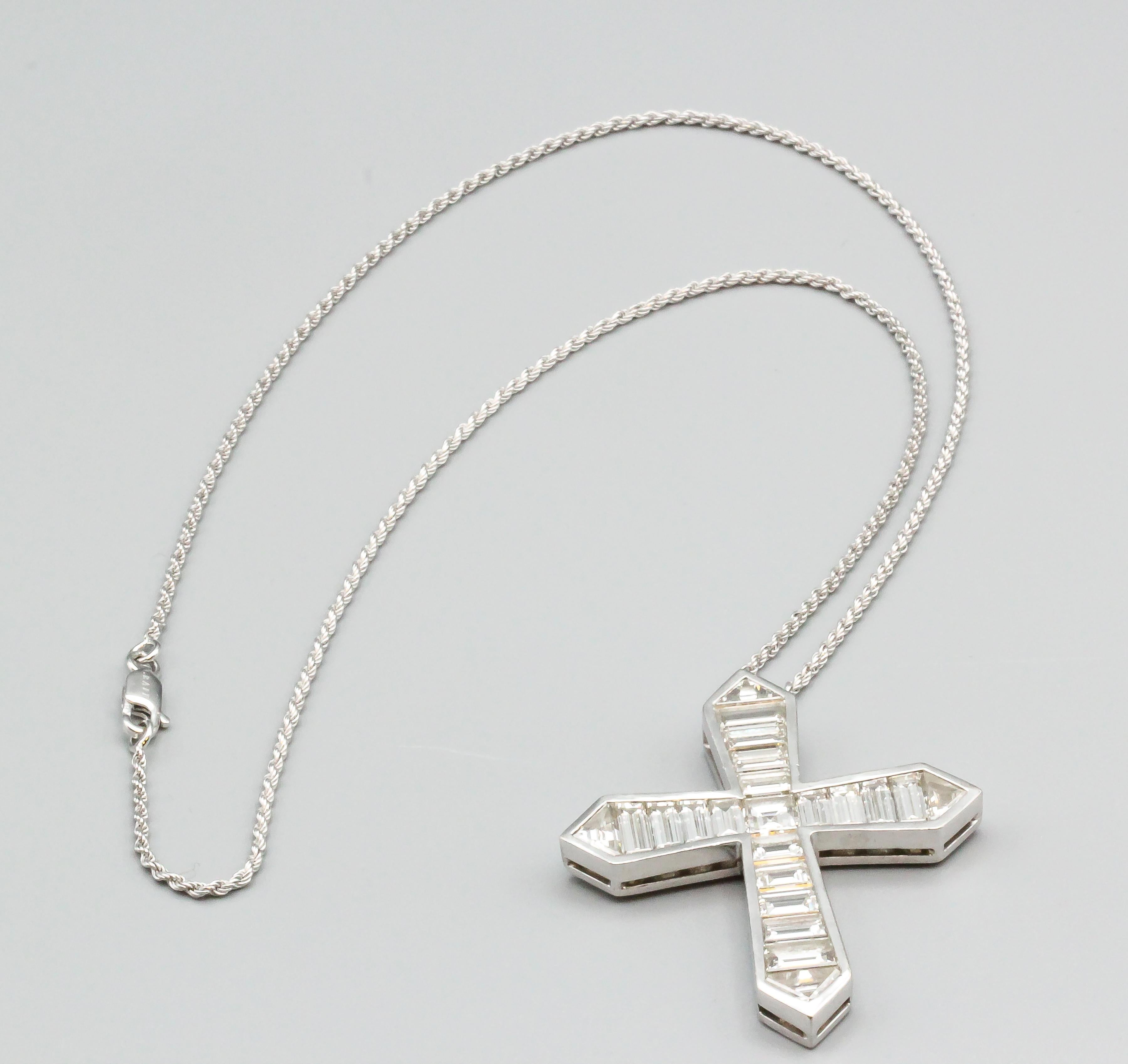 Very fine diamond and 18K white gold cross pendant necklace by Graff. It features high grade square step cut, trapezoid cut and triangle cut diamonds, approx. 8.0-10.0cts total weight. Pendant measures 2