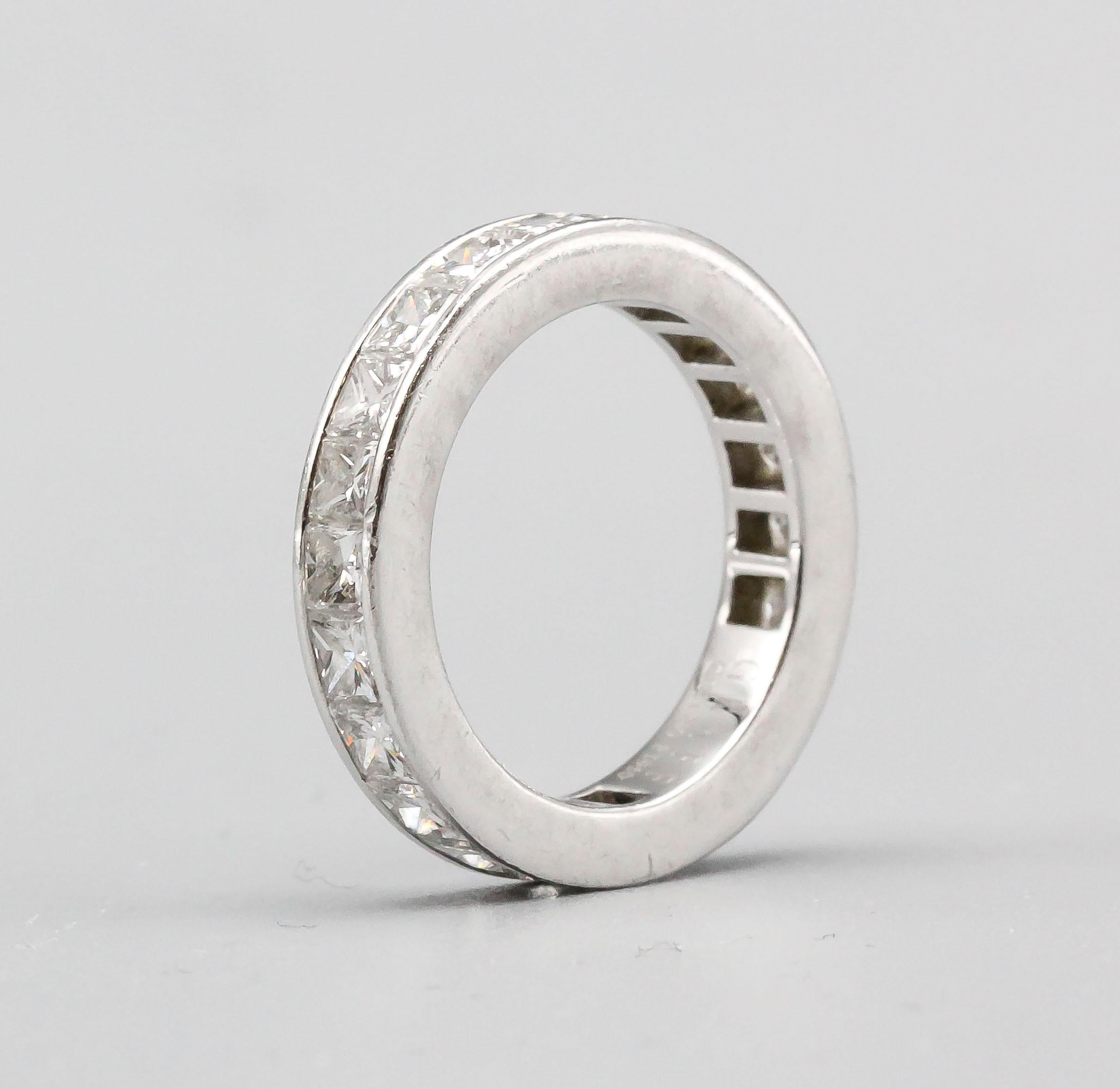 Elegant diamond and platinum eternity ring by Graff. It features 22 high grade princess cut diamonds, weighing 3.27cts total weight. Color: fine White. Clarity VS+. With Graff certificate of quality and original box. Approx. size 5.

Hallmarks: