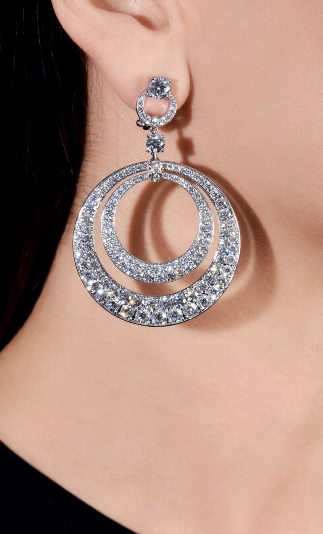 An incredible set Graff diamond earrings showcasing a double hoop design set with brilliant-cut diamonds totalling 17,80cts appx. The earrings have a post and hinge back fittings for safety. The earrings are signed Graff, numbered, and include pouch