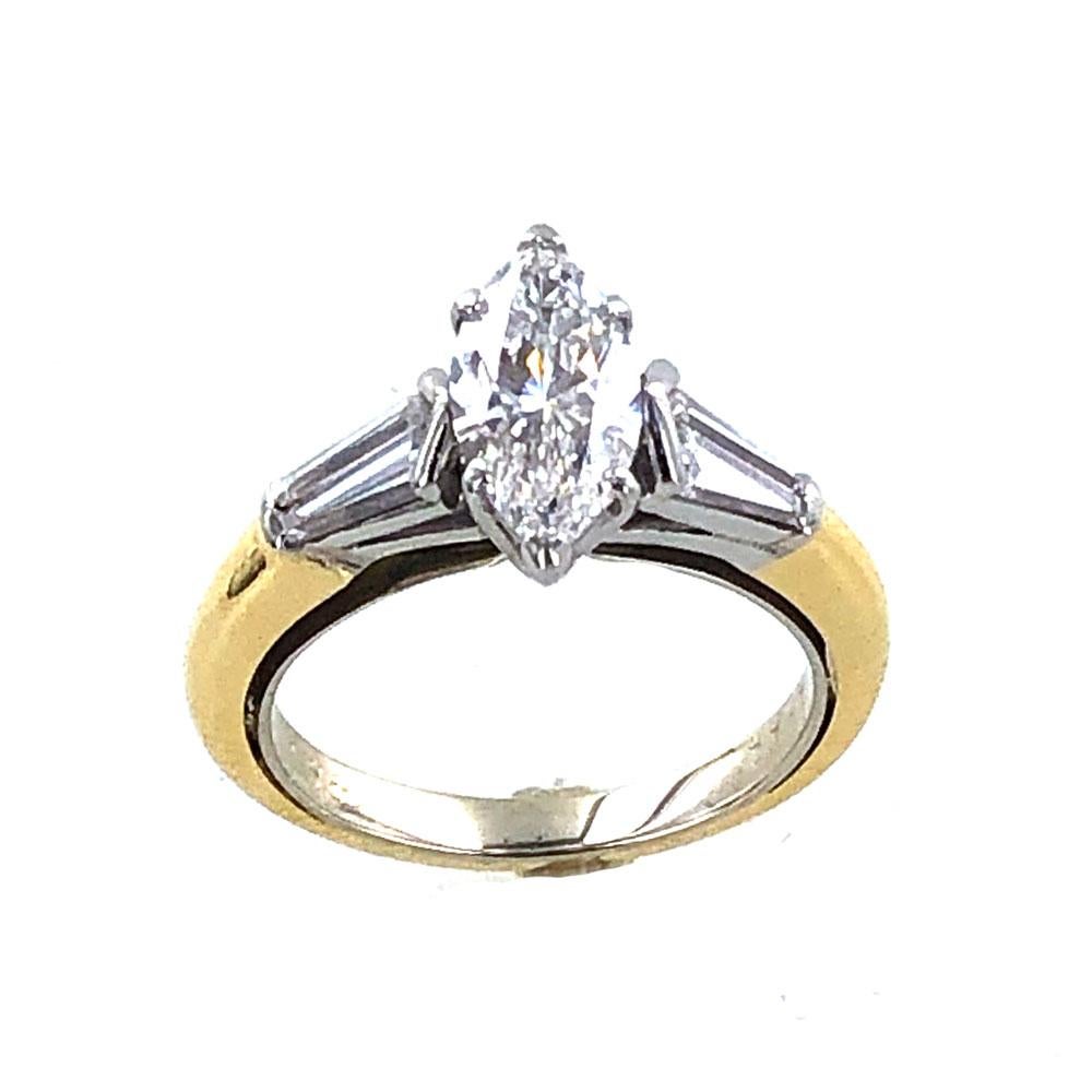 Graff diamond engagement ring bought in London circa 1990. The 1.11 carat marquise diamond is graded E-F color and VS1 clarity. The platinum and 18 karat yellow gold mounting features 4 baguette diamonds weighing .46 carat total weight. The ring