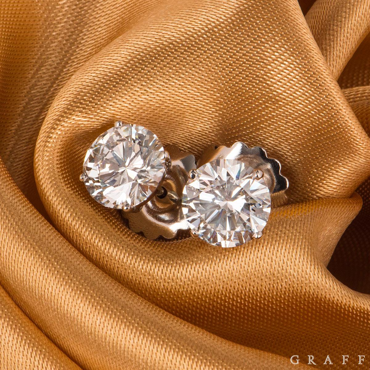 A stunning pair of diamond platinum earrings by Graff. The earrings are set with a round brilliant cut diamond in a 4 claw setting. The earrings are both 2.14ct each, H colour, one earring with VS1 clarity and the other VS2. The earrings feature a