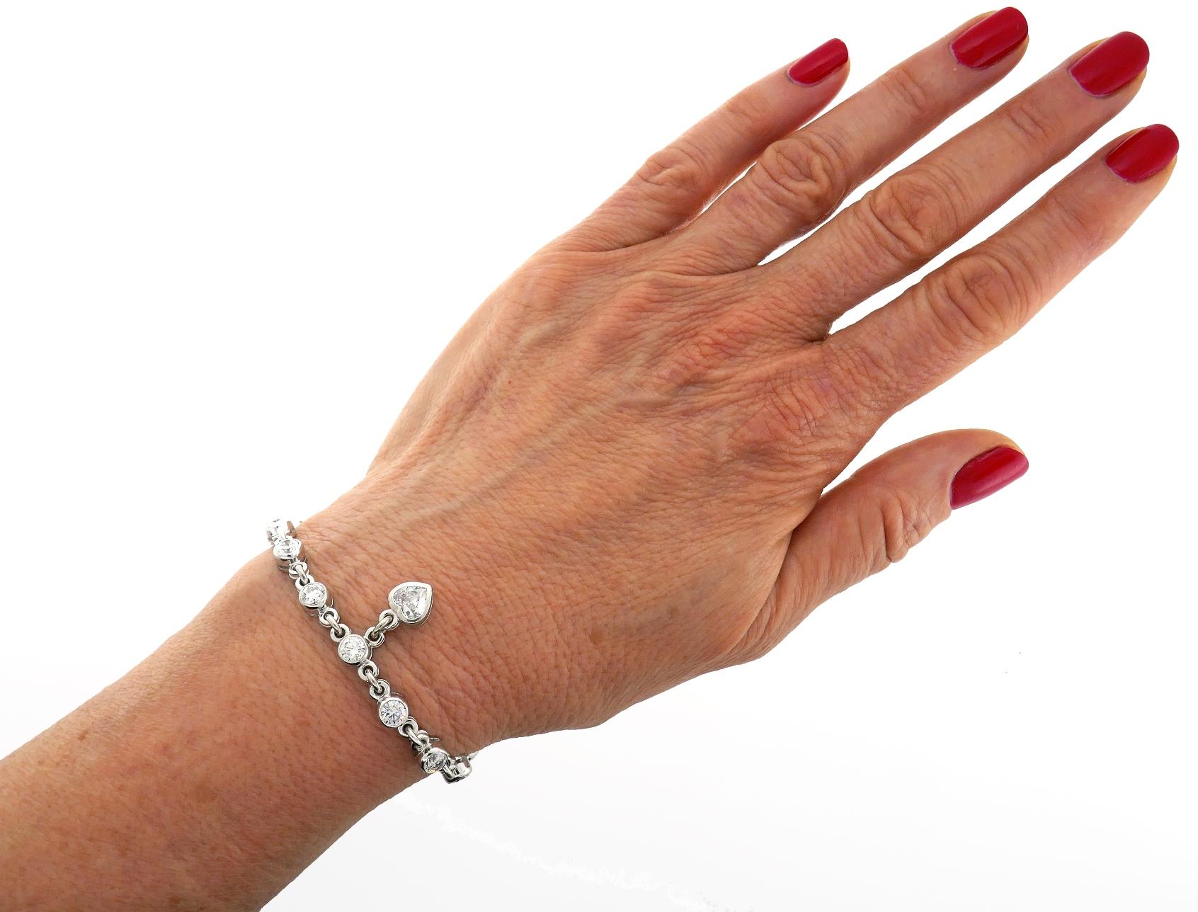 Stunning diamond and 18 karat white gold tennis bracelet created by Laurence Graff. The bracelet features fourteen perfectly matching round brilliant cut (approximately 0.25-carat each) and one heart brilliant cut (approximately 0.75-carat)
