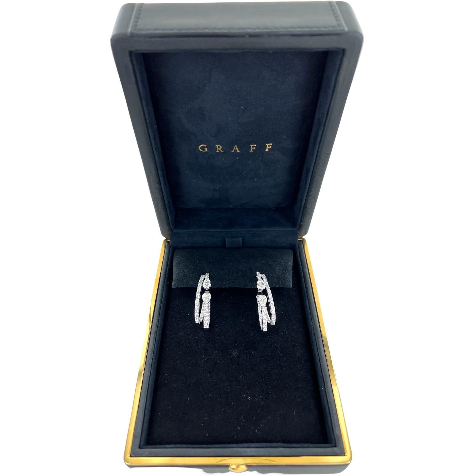 Stunning Duet Diamond Double Hoop earrings by Graff. The modern earrings feature round brilliant and four pear shape diamonds weighing 3.85 CTW and graded D-F color and VVS clarity. The earrings measure 1.50 inches in length, feature lever-backs,