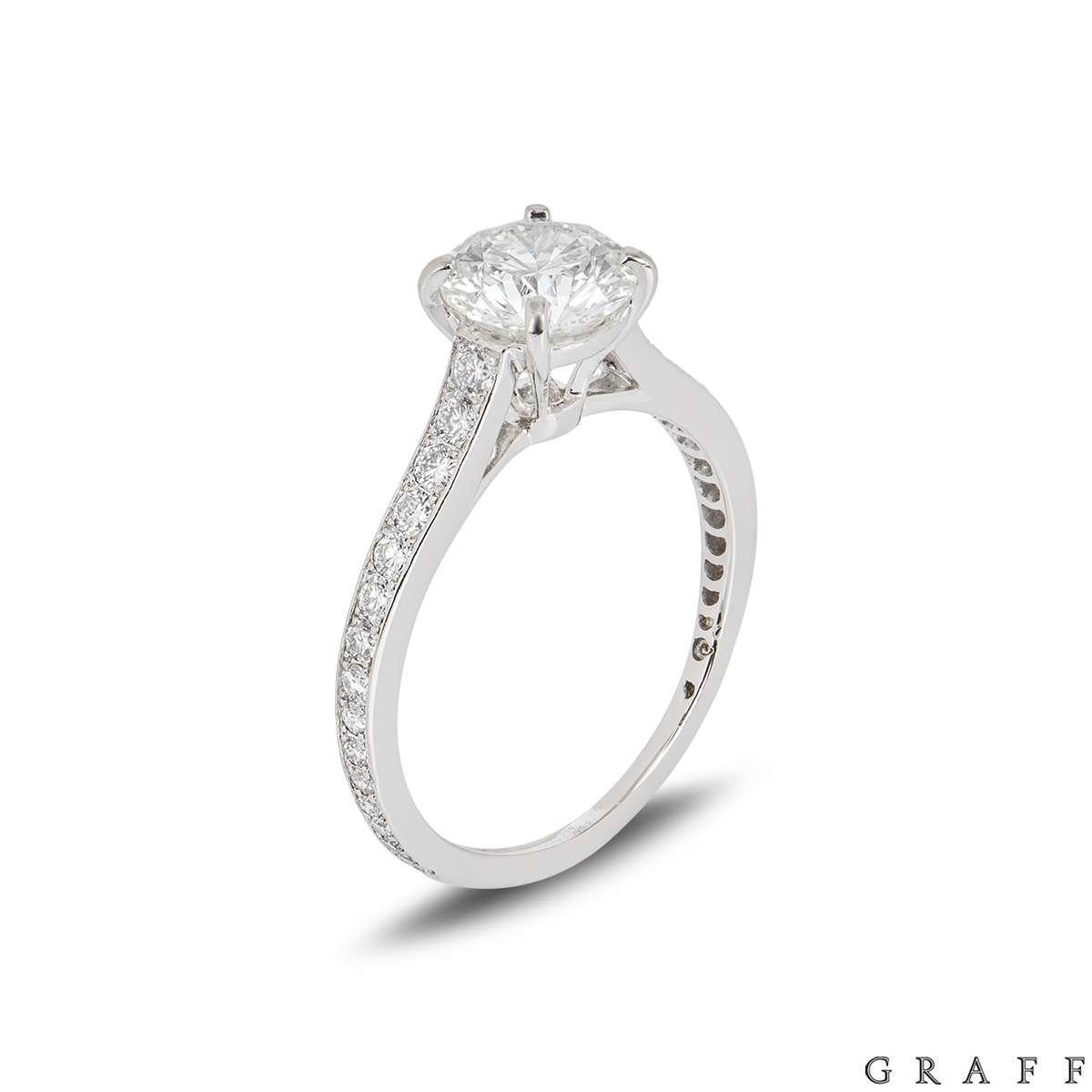 A stunning platinum ring by Graff from the Flame collection. The ring comprises of a round brilliant cut diamond in a classic four claw setting with a weight of 1.03ct, I colour and VVS2 clarity. Set to either side of the diamond is 16 round