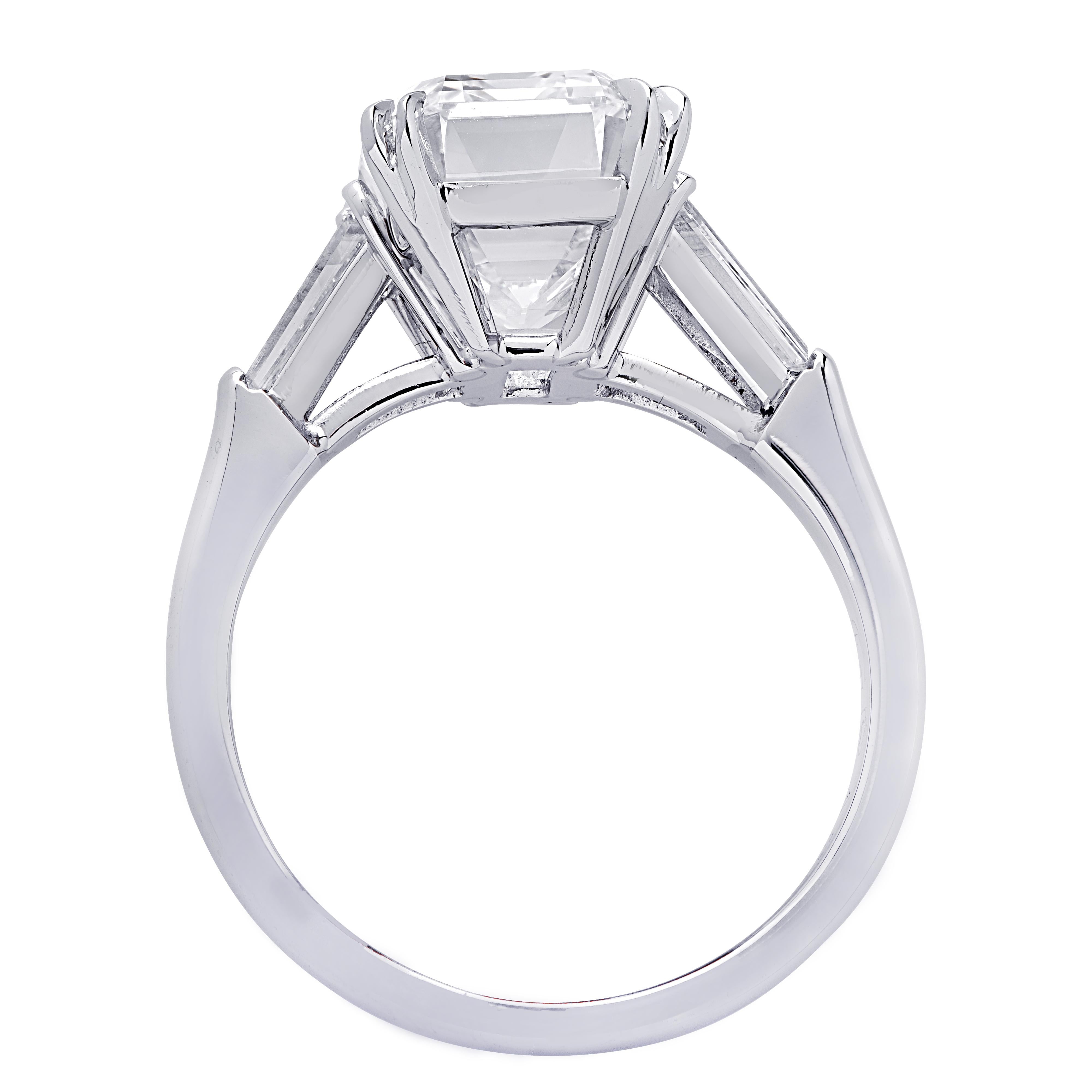 From the renowned House of Graff, this sensational engagement ring, finely crafted in Platinum, showcases a spectacular GIA Certified Emerald Cut Diamond weighing 5.08 carats, D color, Internally Flawless. This stunning diamond is adorned with two