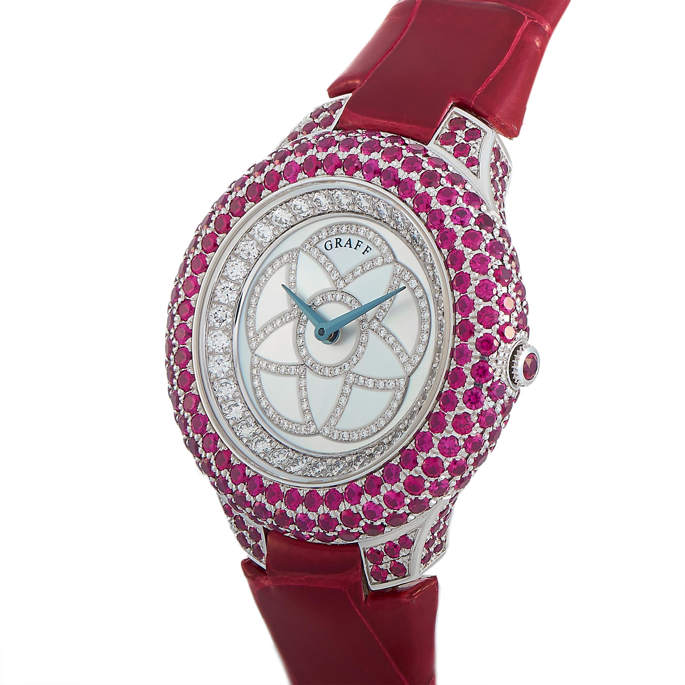 This is the Graff Halo Ruby watch, reference number GHWGRMP.

It is presented with a 36 mm 18K white gold case embellished with a plethora of rubies. The case is mounted onto a red leather strap fitted with a tang buckle. The watch is offered with a