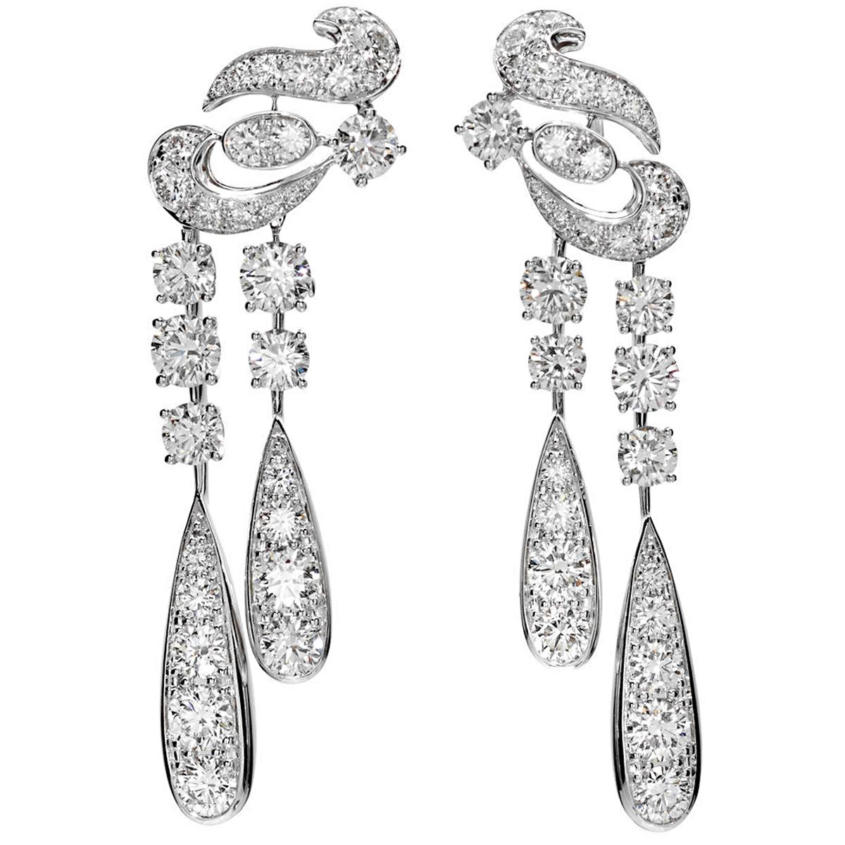 An incredible pair of Graff earrings designed in a swirl motif and suspending diamond drops with the finest Graff round diamonds weighing appx 10.65cts. The earrings are mounting in shimmering 18k white gold and measure 2.37
