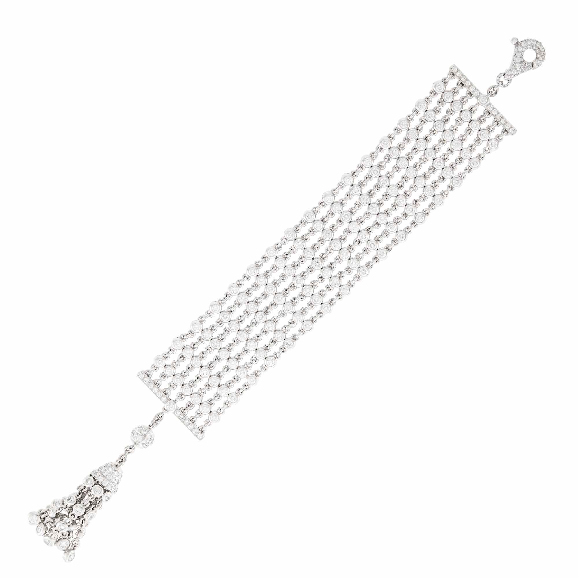  GRAFF Multi strand Platinum and Diamond Chain Tassel Bracelet Composed of seven
strands of circle links spaced by 112 collets et round diamonds, stationed by slender bar links, with ball and tassle chain accented by round diamonds, totaling 210