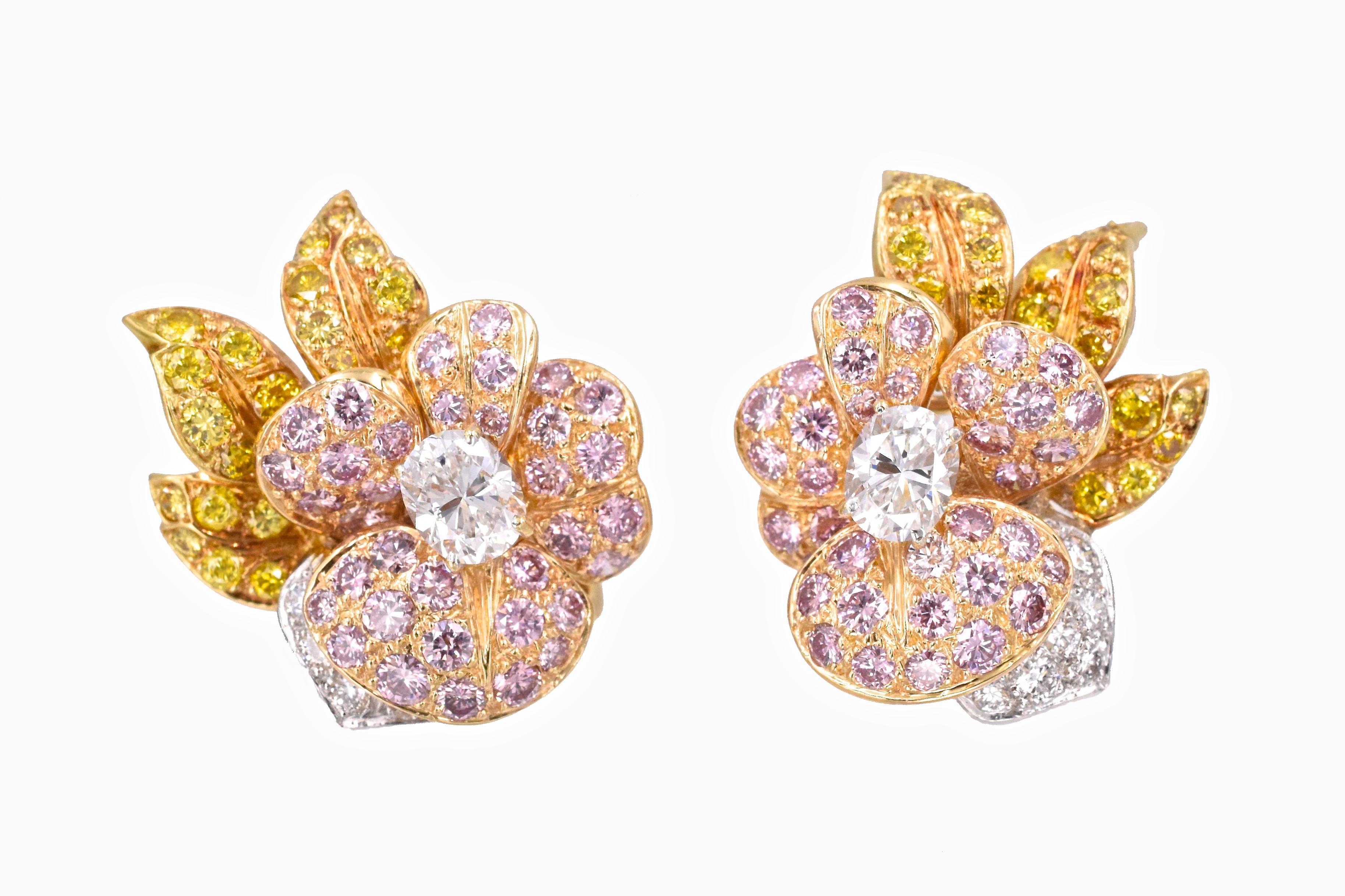 Beautiful floral ear clips by GRAFF 
 2 center oval  diamonds  are   1.20 carats E/F color VS1 clarity
40 Natural yellow  diamonds  are  2.0 carats set in yellow gold
70 Natural pink diamonds  are   3.0 carats set in pink gold
12 Natural white