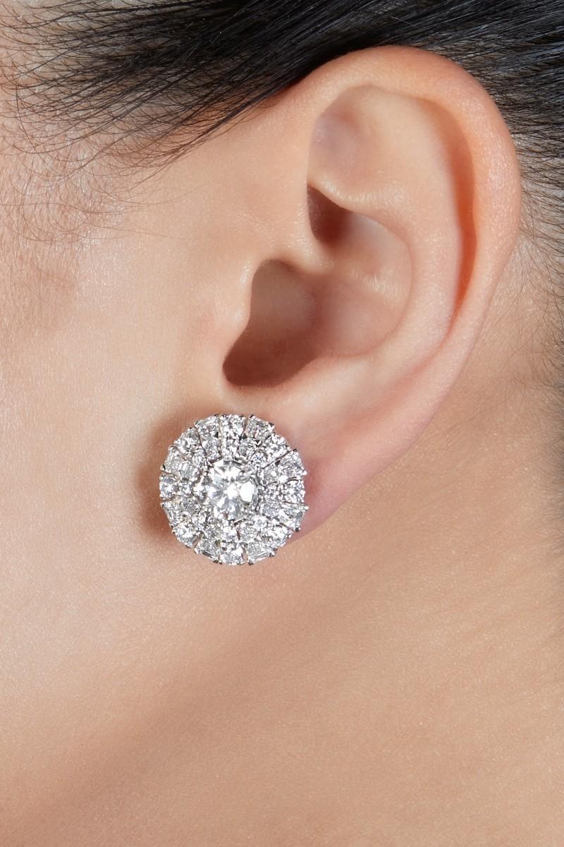 These Graff earrings feature two round diamonds weighing 1.05, and 1.02 carats which are framed by round and baguette diamonds. Fitted with posts. Signed Graff. 

Accompanied by two GIA reports:
﻿No. 6131181489 dated March 27, 2012 stating that the