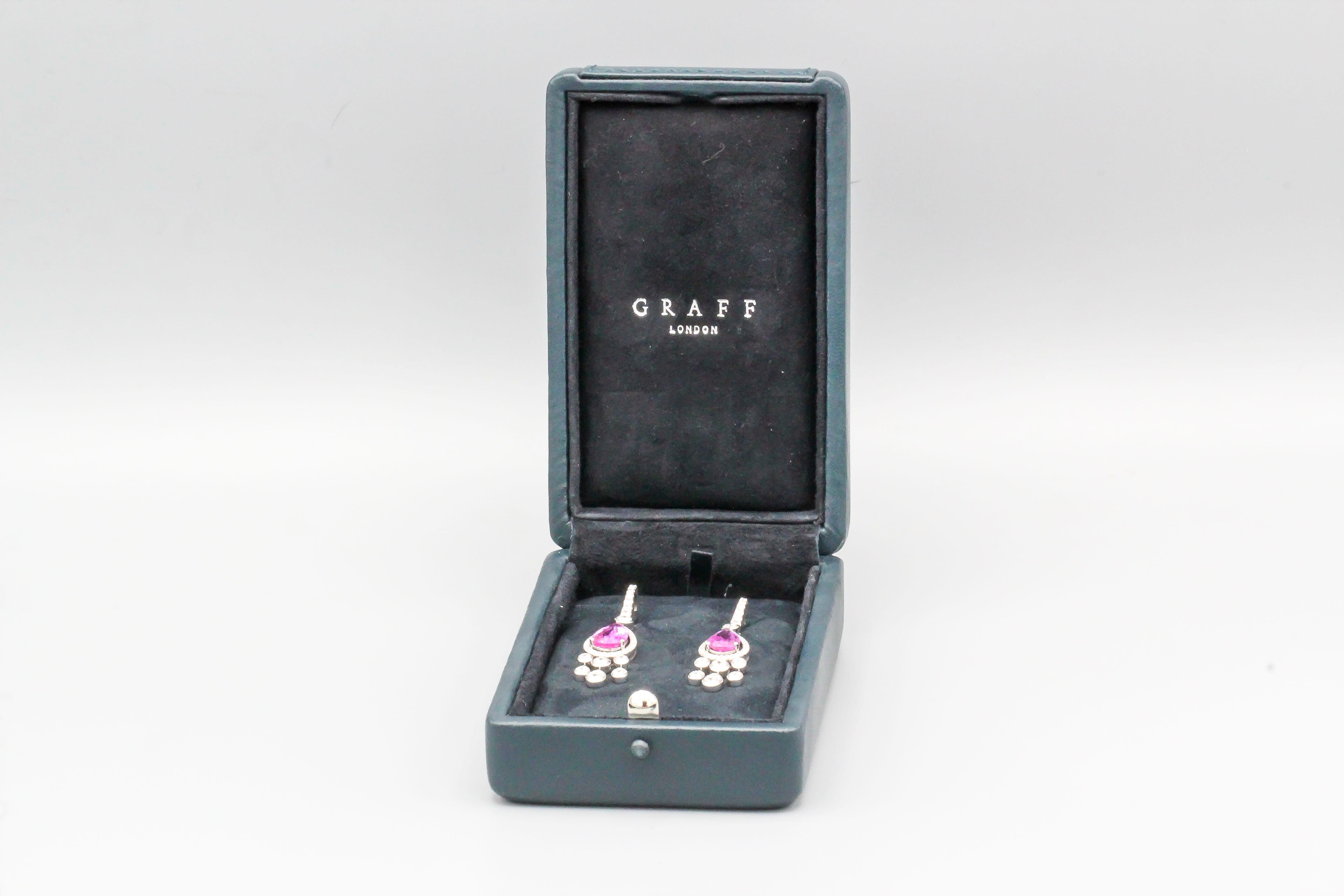 Fine pair of pink sapphire and diamond drop earrings by Graff, set in 18k white gold.  Sapphire are approx 5-6 carats in total weight. With original box.


Hallmarks: Graff, AU750, reference numbers.