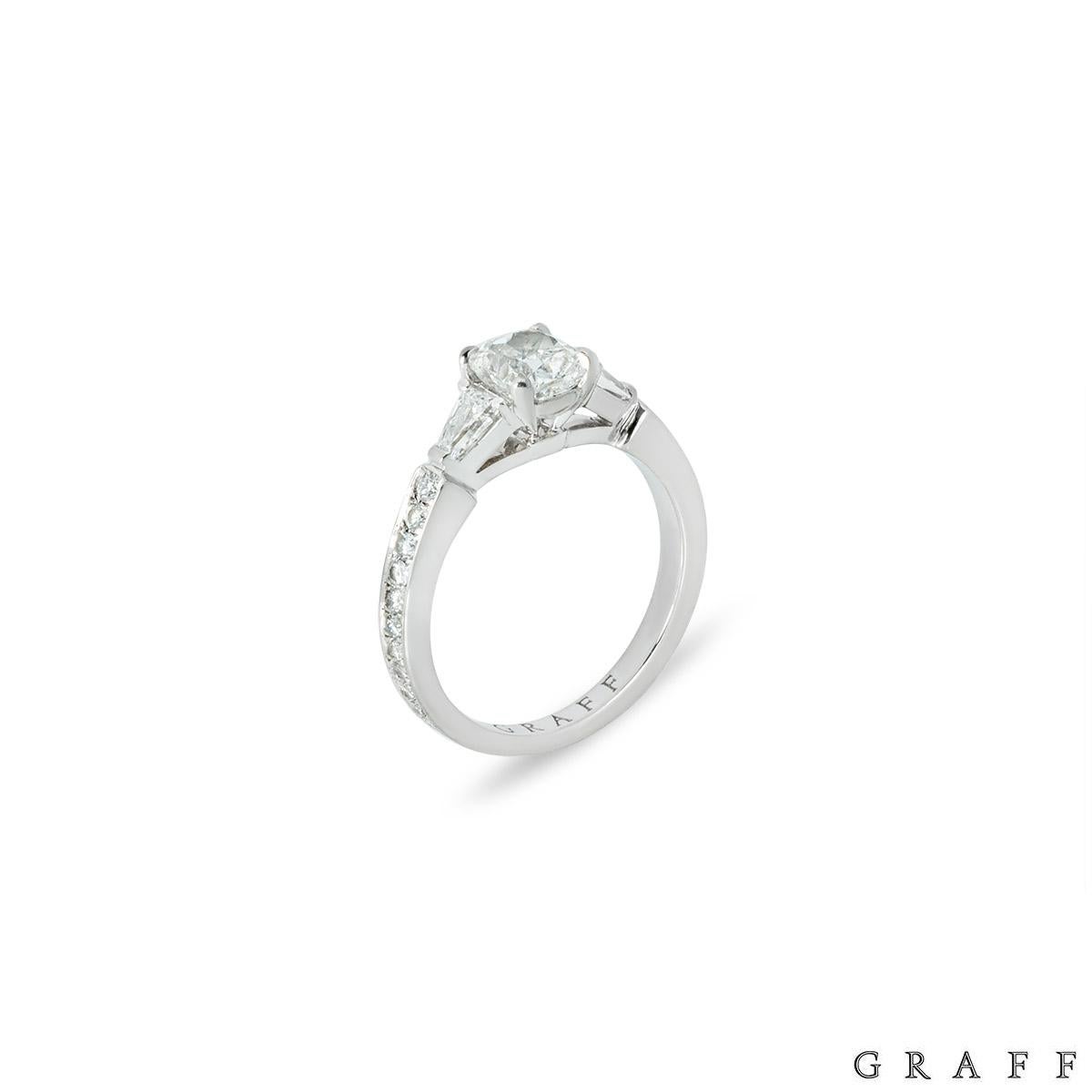 A gorgeous platinum diamond engagement ring by Graff from the Promise collection. The centre of the ring is adorned with a cushion cut diamond weighing 0.90ct, G colour and VS1 clarity. The centre stone is flanked by two tapered baguette cut