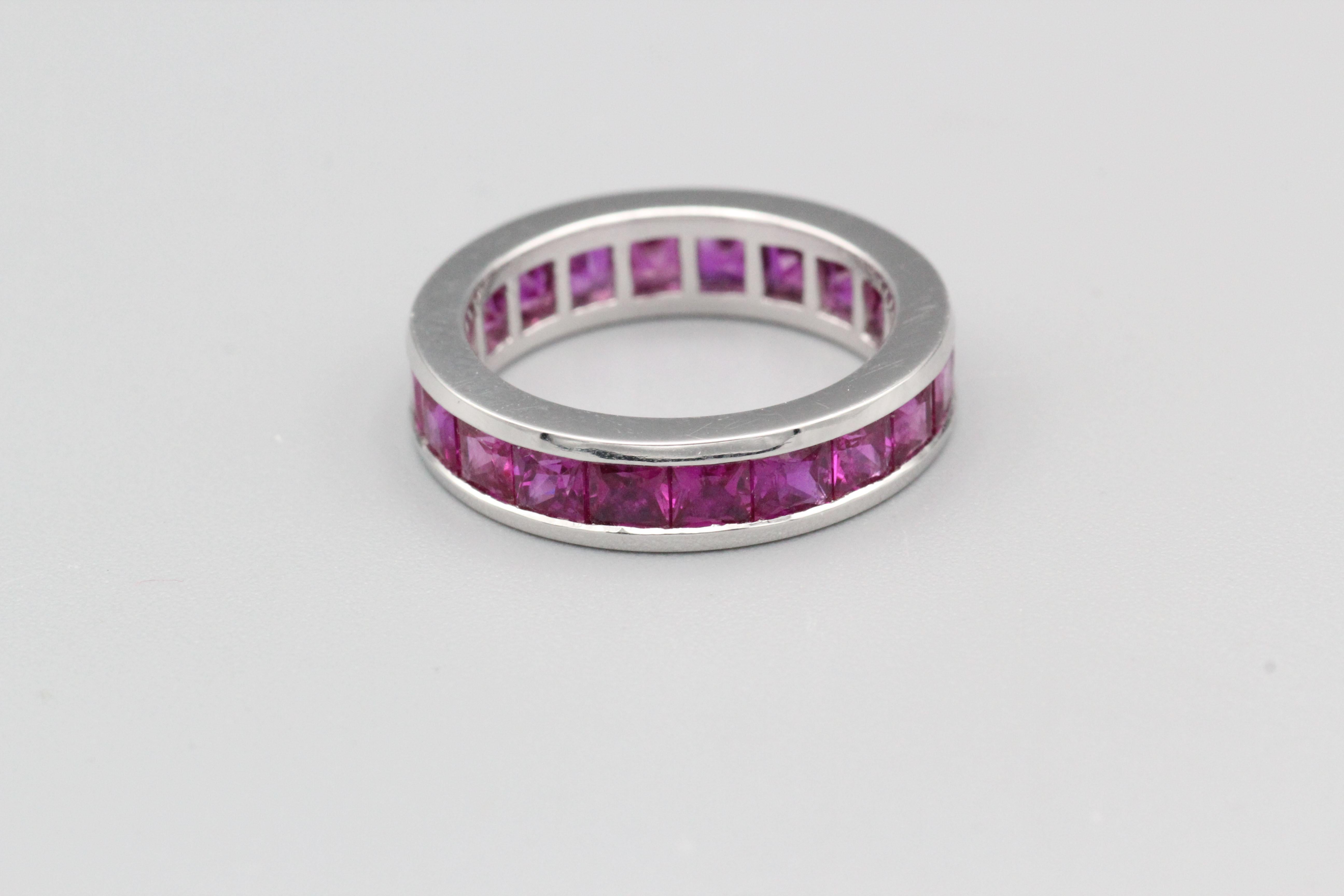 A very fine Graff princess cut ruby and platinum band.  The band is made of high-quality platinum, a durable and precious metal that is known for its strength, purity, and luster.  The band is set with a row of square shaped rubies that have been