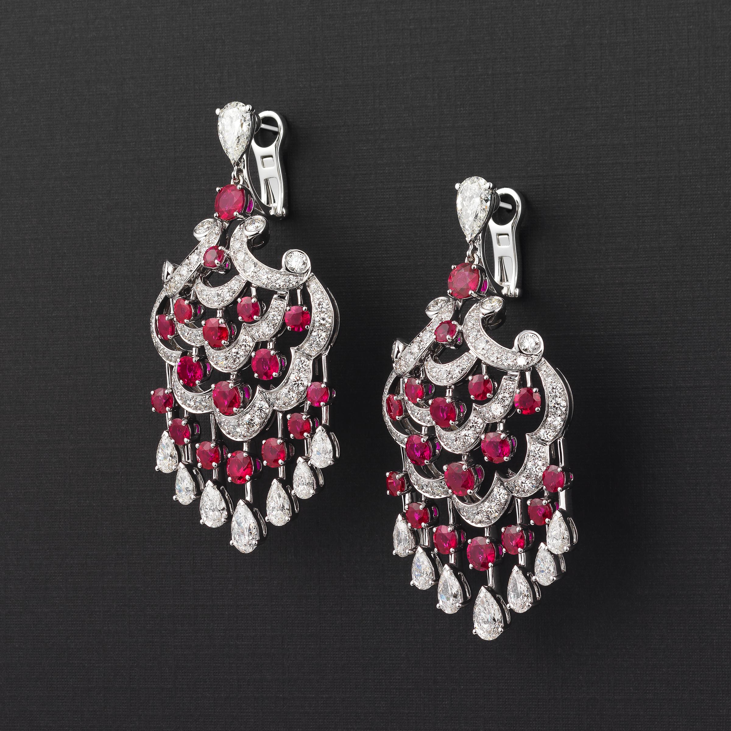 Spectacular Graff chandelier earrings bursting with red-carpet glamour and vibrant style and showcasing 10 carats of radiant fine white diamonds (approximately F to G color) and another 10 carats of vivid red Burma rubies, all flawlessly set in 18