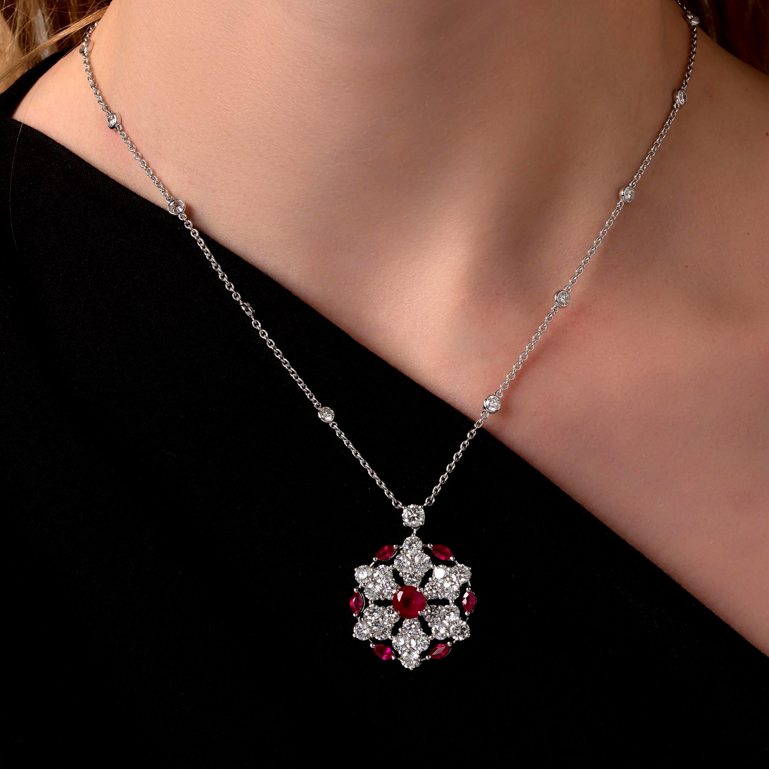 A fabulous Graff Ruby and Diamond necklace showcasing a pendant set with brilliant-cut diamonds, marquise-cut rubies and a central circular-cut ruby, on a cable link chain adorned with round brilliant cut diamond stations. The necklace is mounted in