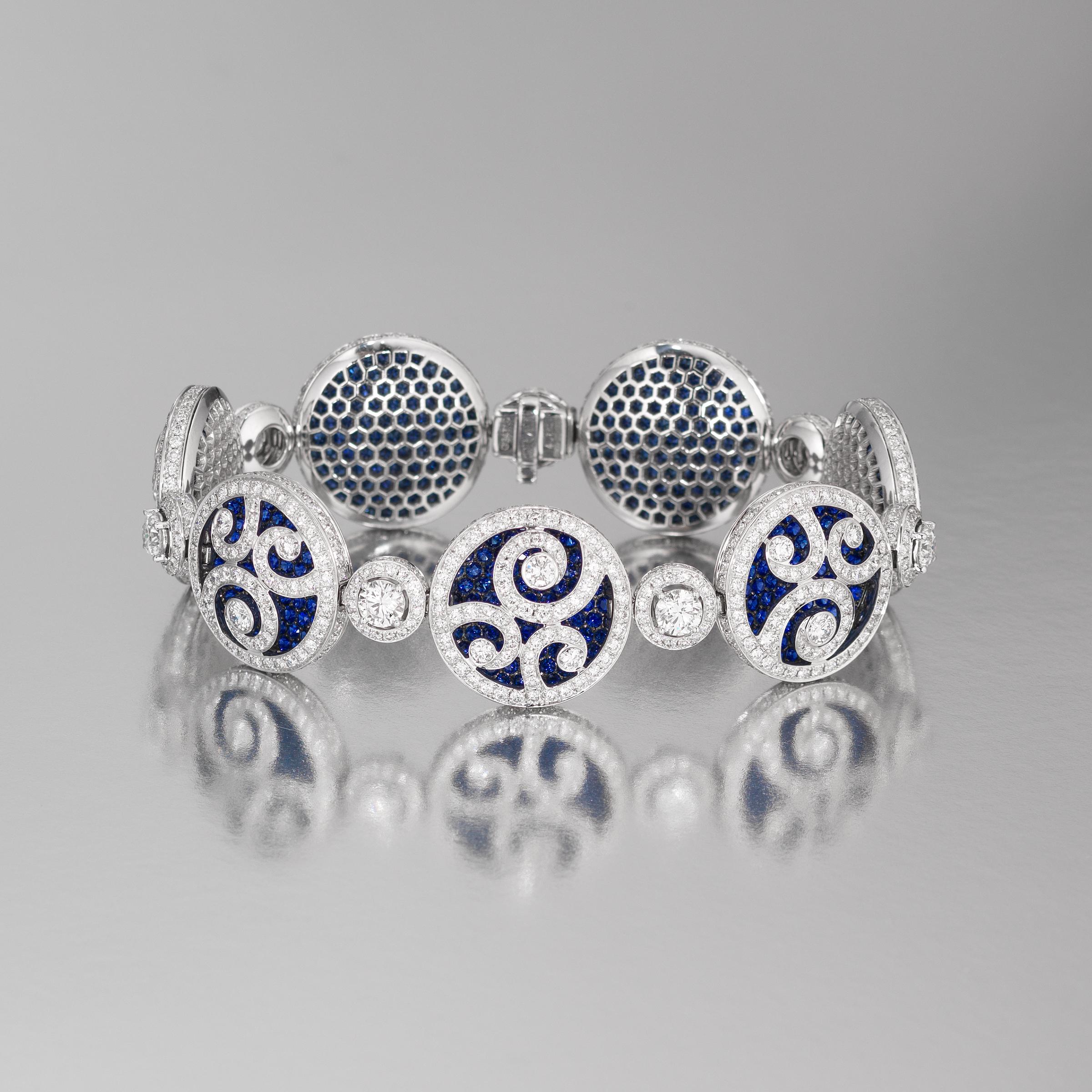 Exceptional Graff high jewelry bracelet of dazzling medallion design and showcasing 11.65 carats of finest white diamonds (approximately E to G color, VVS to VS clarity) and 10.93 carats of richly-hued blue sapphires, all set in 18 karat white gold.