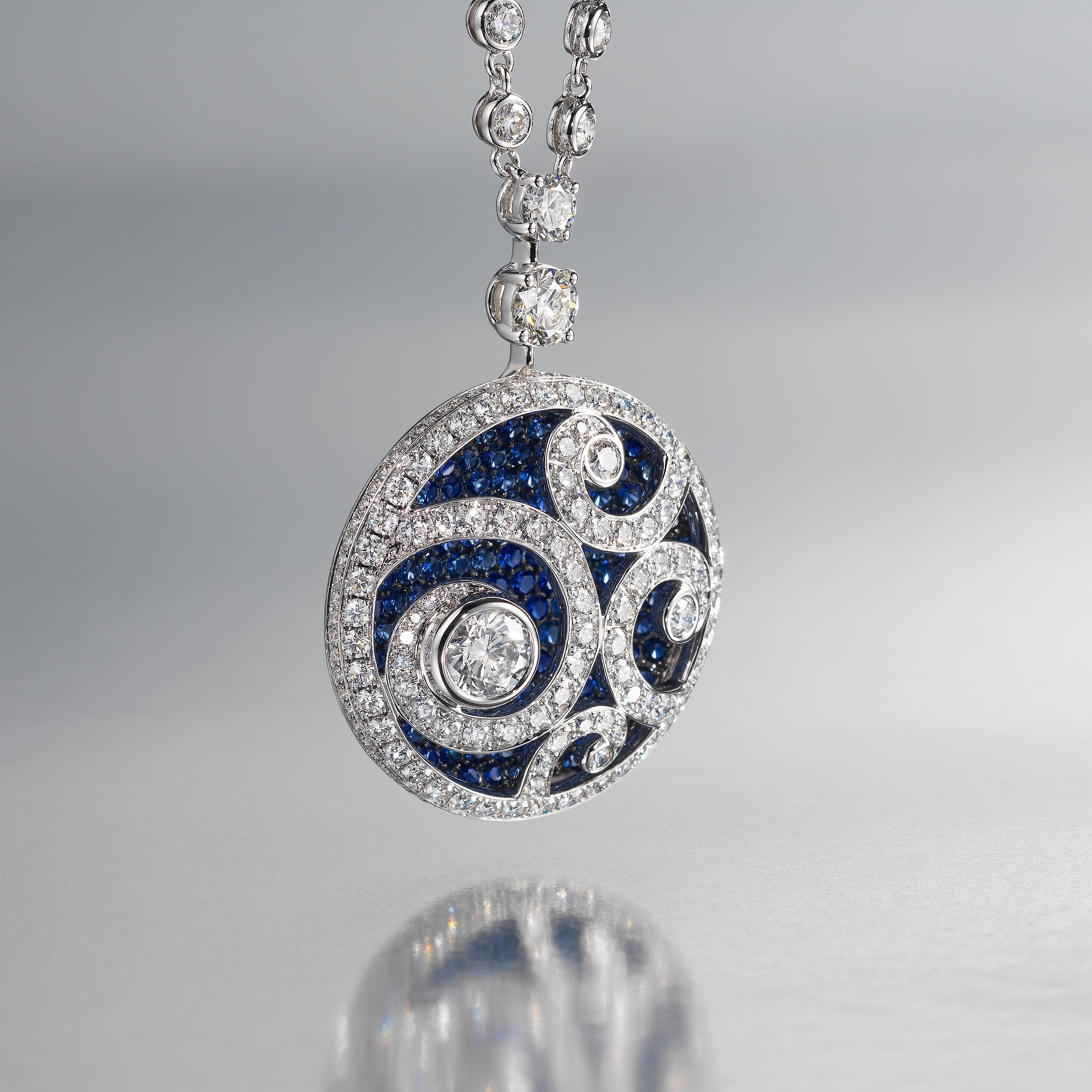 Exquisite Graff pendant necklace of dazzling medallion design and showcasing approximately 8 carats of finest white diamonds (approximately D to G color, VVS to VS clarity) and 3.7 carats of richly-saturated blue sapphires, all set in 18 karat white