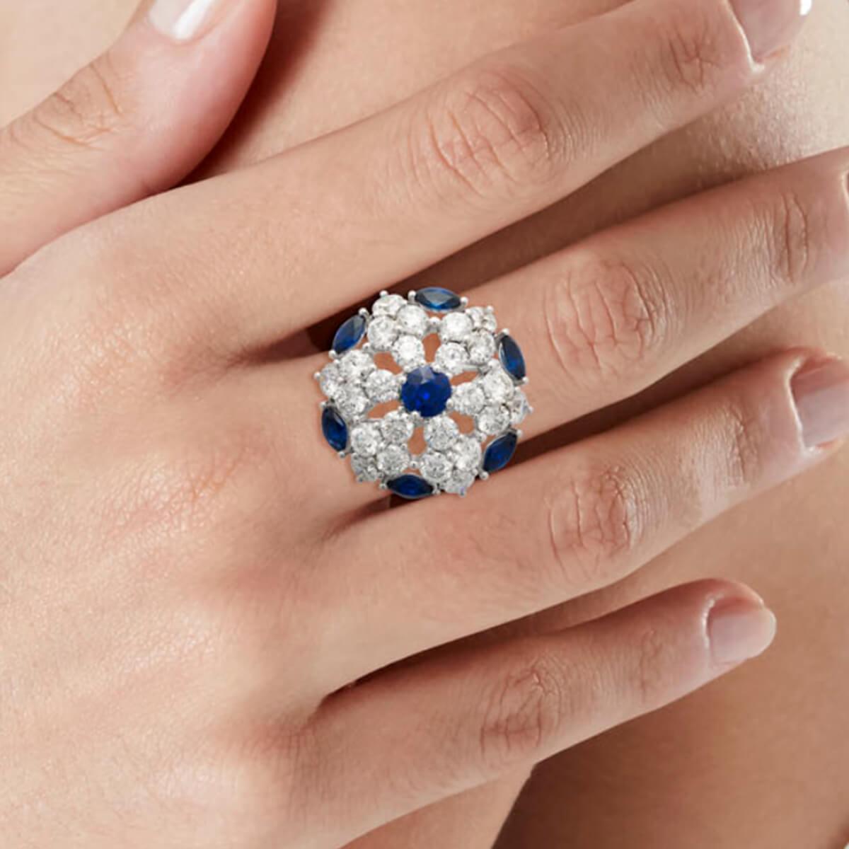 An incredible Graff cocktail ring showcasing the finest round brilliant cut diamonds 6.42ct appx adorned with deep rich blue sapphires in 18k white gold. The ring measures a size 8 and can be resized.