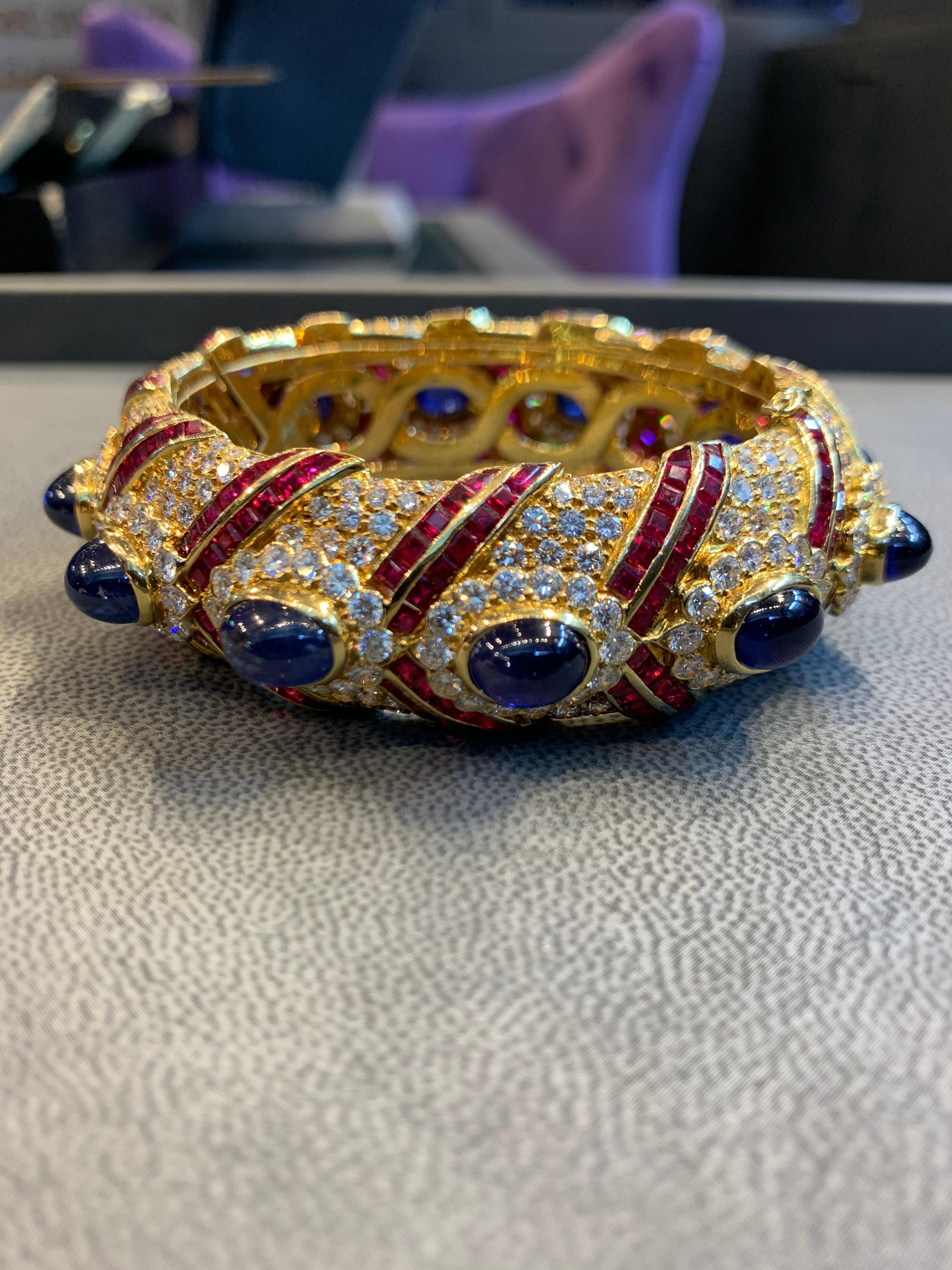 Graff  Cabochon Sapphire, Ruby , And Pave Diamond Large Gold Bangle Bracelet
Inner Circumference: 170mm
Approx 20.00 cts of diamonds
Made:1986 
