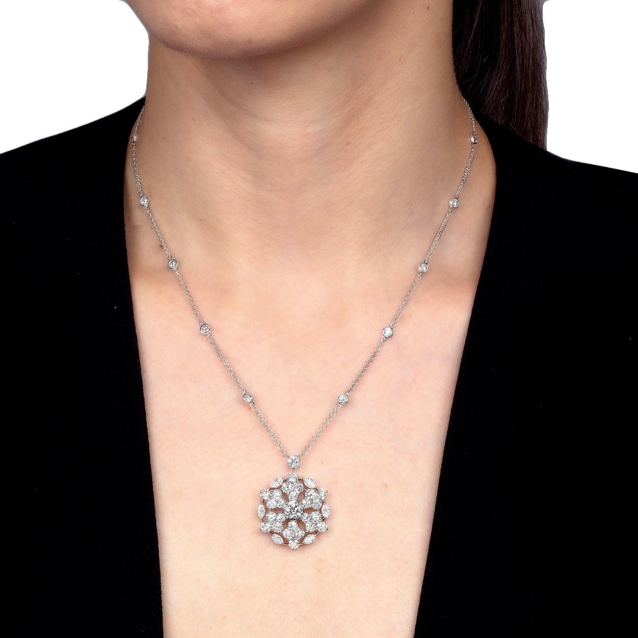 A magnificent diamond pendant necklace by Graff showcasing a Snowflake motif adorned with marquise and round brilliant cut diamonds. Throughout the chain there are diamond stations, the total carat weight measures 6.67ct. The central diamond