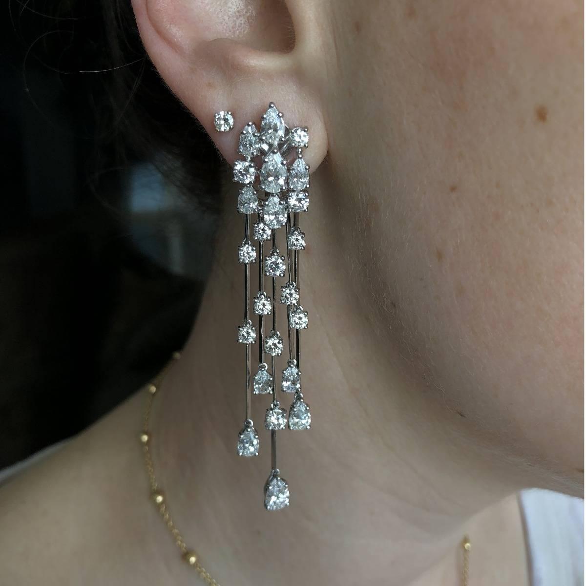 A magnificent pair of Graff earrings featuring a plethora of pear and round brilliant cut diamonds in platinum. These stunning earrings feature 3.39ct of VS, F color round brilliant cuts and 7.13ct of VS, F color pear shaped diamonds.

The earrings