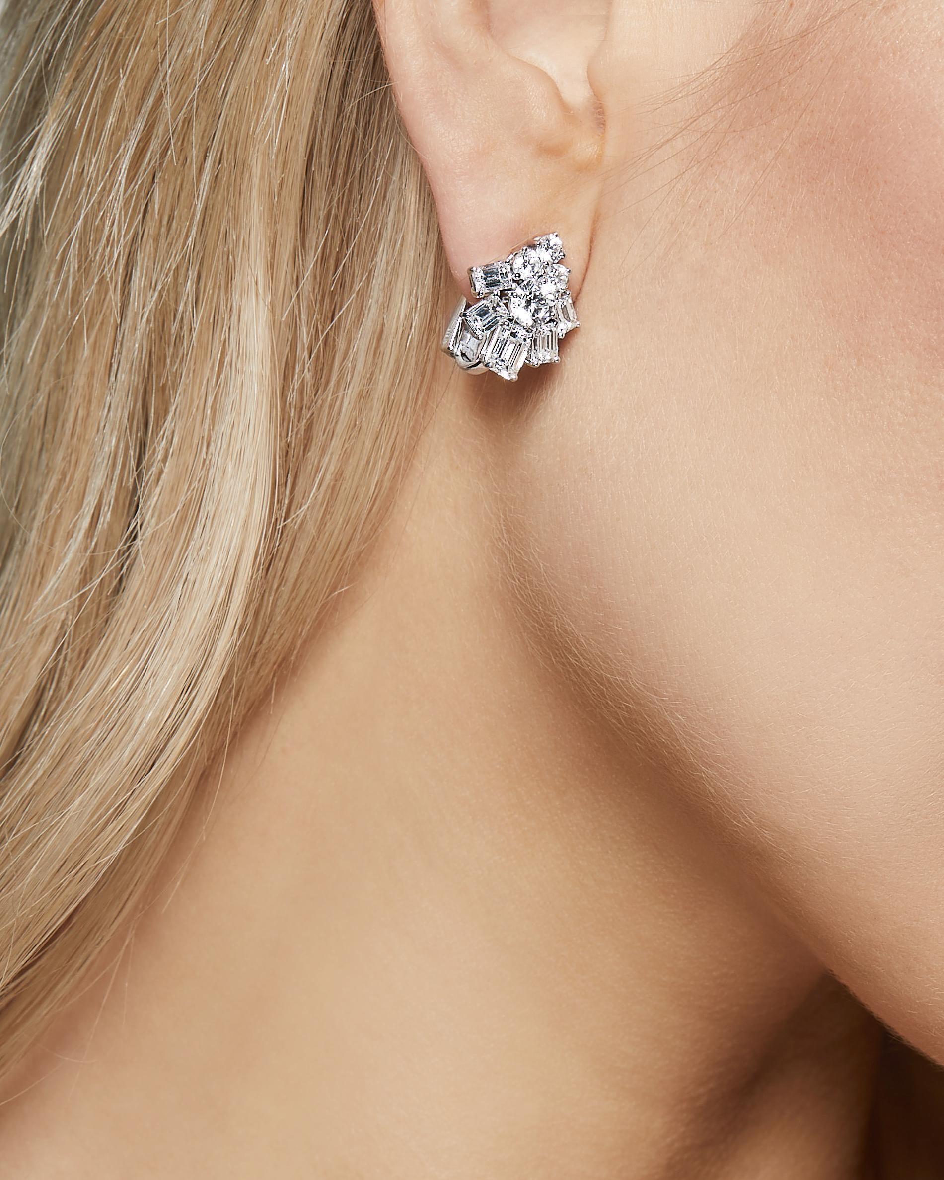 Introducing the stunning Graff White Gold and Platinum Earrings, adorned with emerald-cut and round diamonds to create a mesmerizing display of brilliance and sophistication.

 Crafted from the finest white gold and platinum, these earrings feature