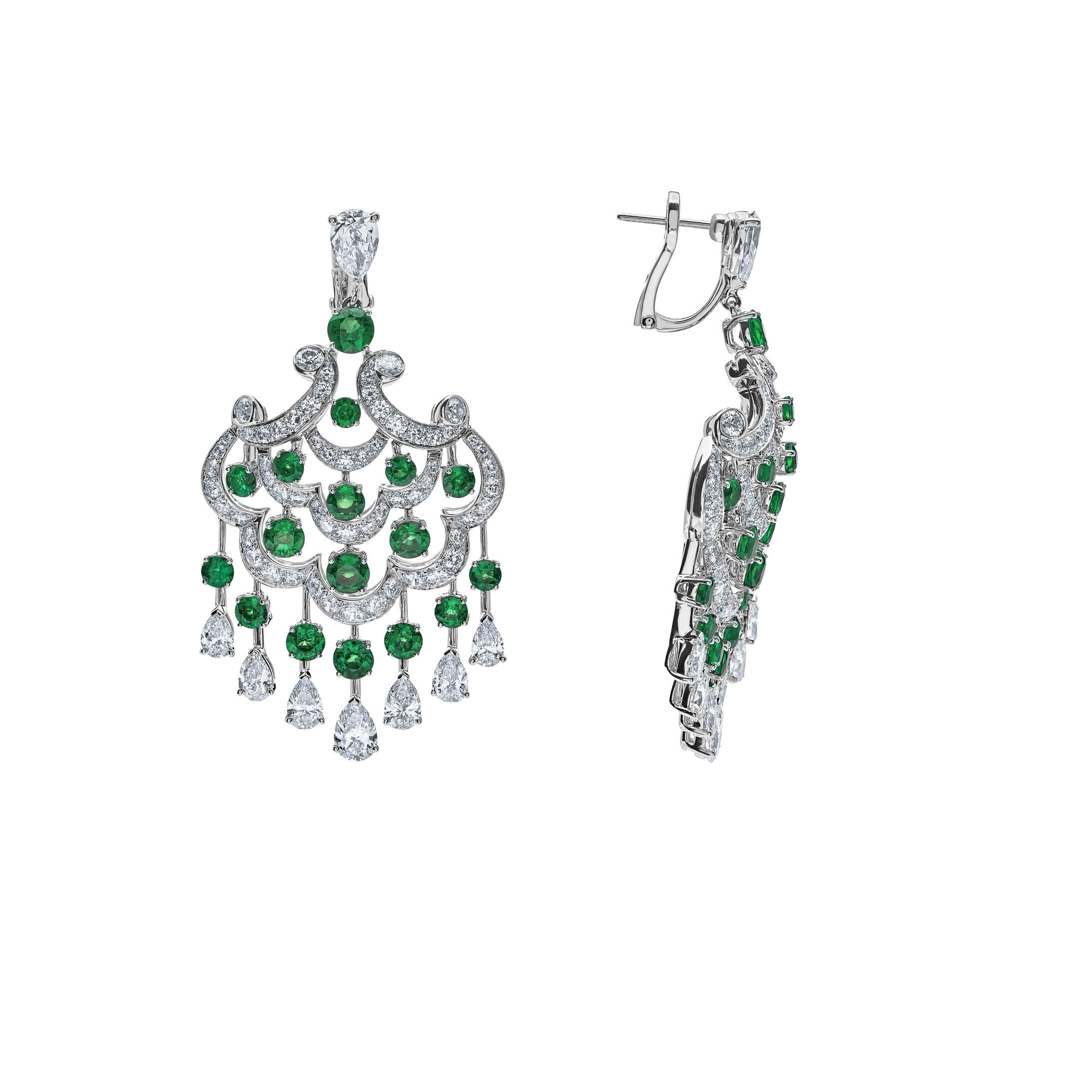 Immerse yourself in the elegance of this exquisite chandelier design of emerald and diamond earrings. The Graff earrings feature a stunning array of round emeralds and 16 pear-shaped white diamonds in lustrous 18-karat white gold. The elaborate