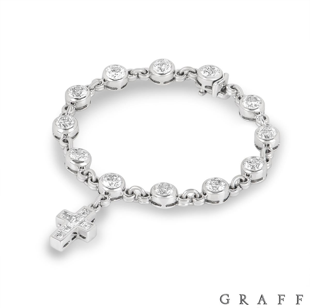 A unique 18k white gold diamond bracelet by Graff. The bracelet features 12 round brilliant cut diamonds in a bezel set mount, evenly spaced throughout. The diamonds have an approximate weight of 9.60ct, E-F colour and VVS-VS clarity. The line