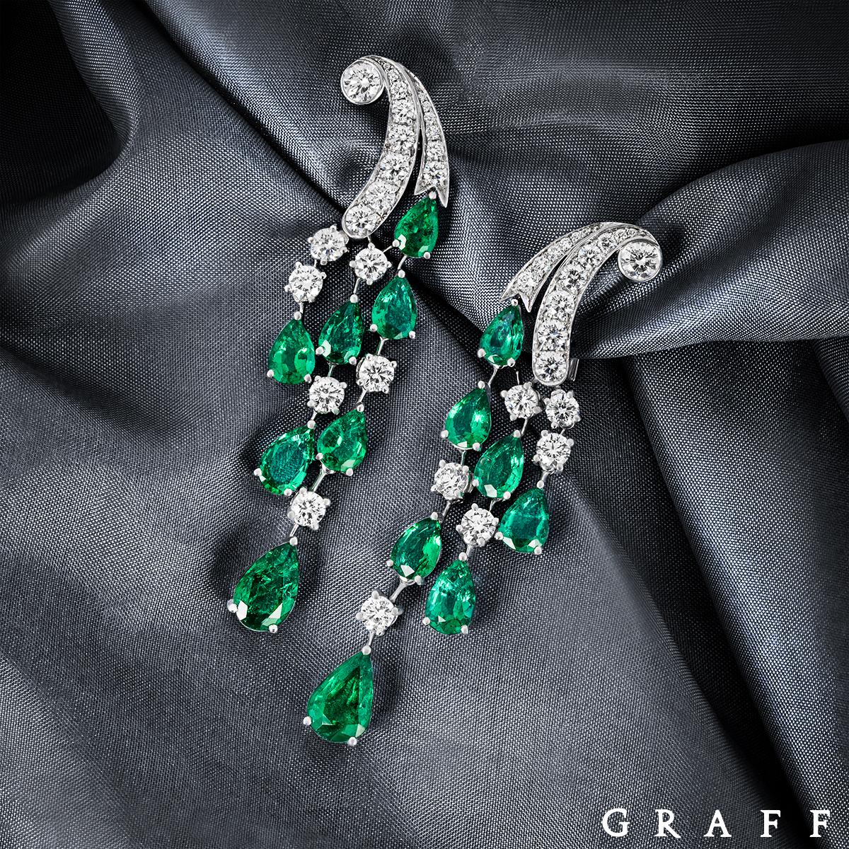 A magnificent pair of 18k white gold emerald and diamond earrings by Graff. The earrings feature a diamond set curved design that leads to 3 freely moving tassels that are set with emeralds and diamonds. There are 14 pear cut emeralds set throughout
