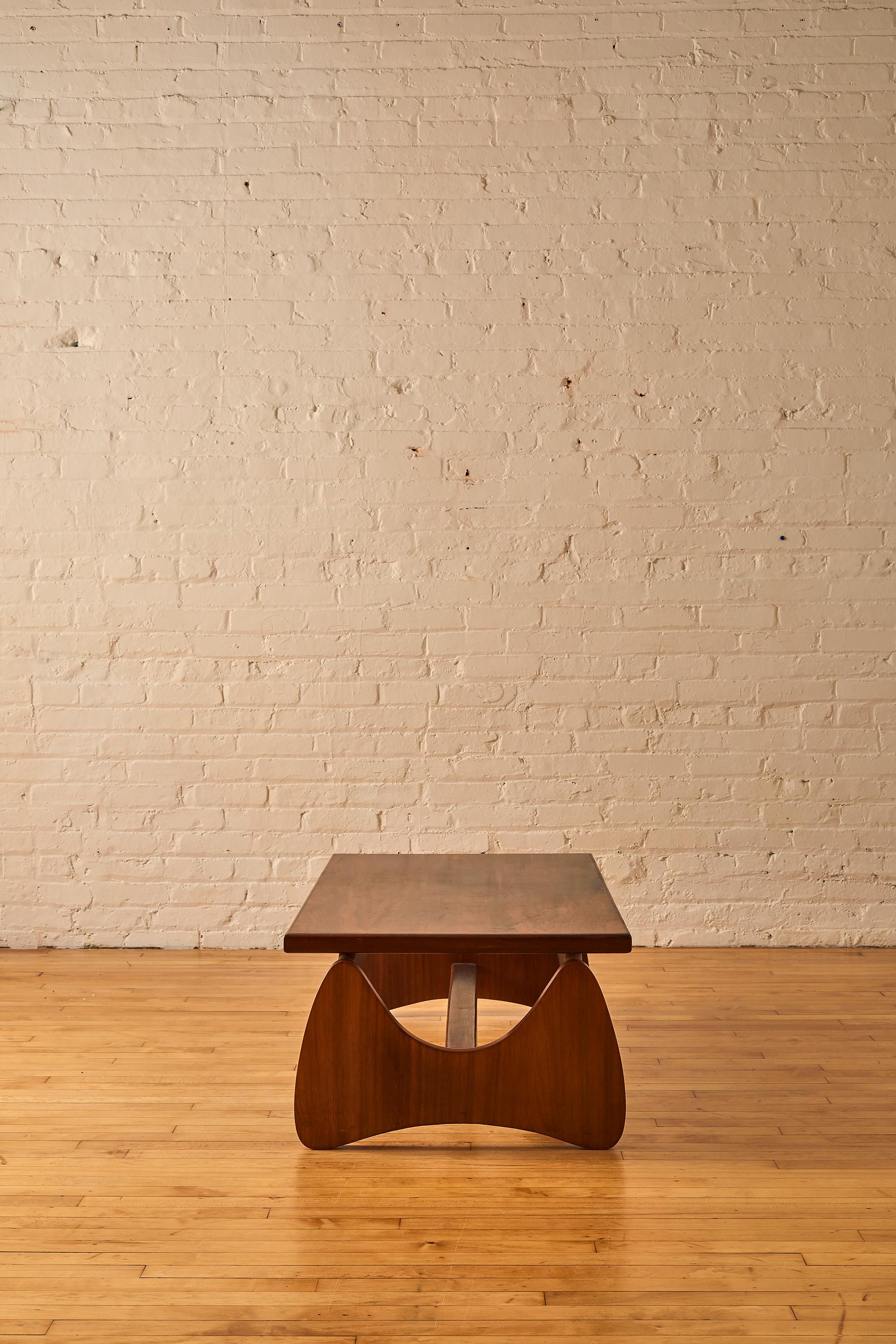 Grafton everest coffee table walnut coffee table with sculptural legs. 

