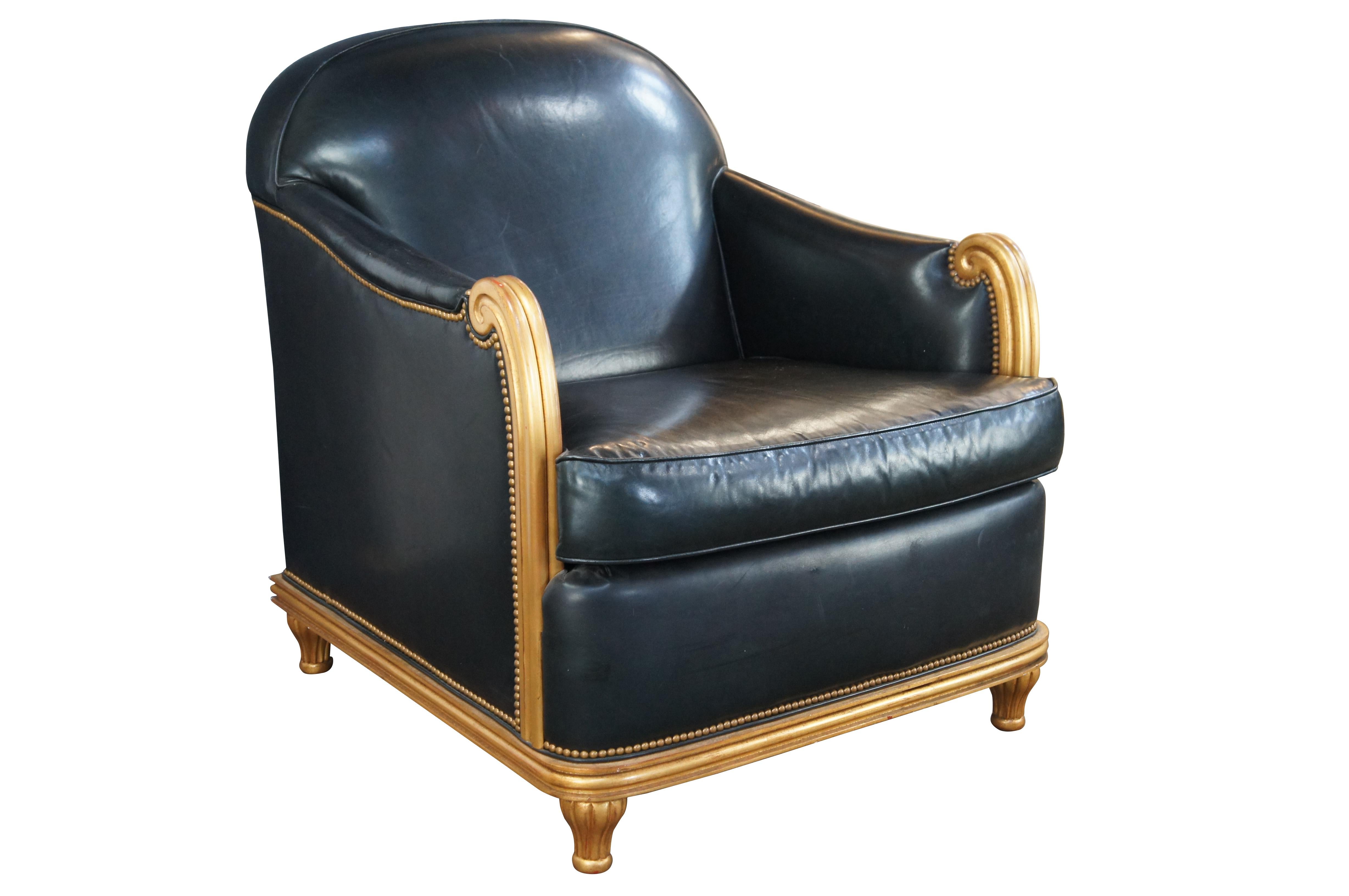 Late 20th Century / Early 21st Club chair by Grafton Furniture. Features a French Art Deco inspired frame with curved back and scrolled arms. The chair is finished in gold with black leather upholstery and brass nailhead trim. The frame is supported