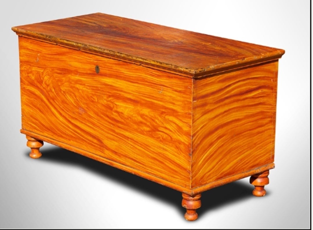 Painted blanket chest with turned feet. Rectangular lid with applied molding above dovetail jointed case . An absolute delight, this festive jewel made of dense poplar with a butternut till has a wonderful, early grain painted surface. The top is