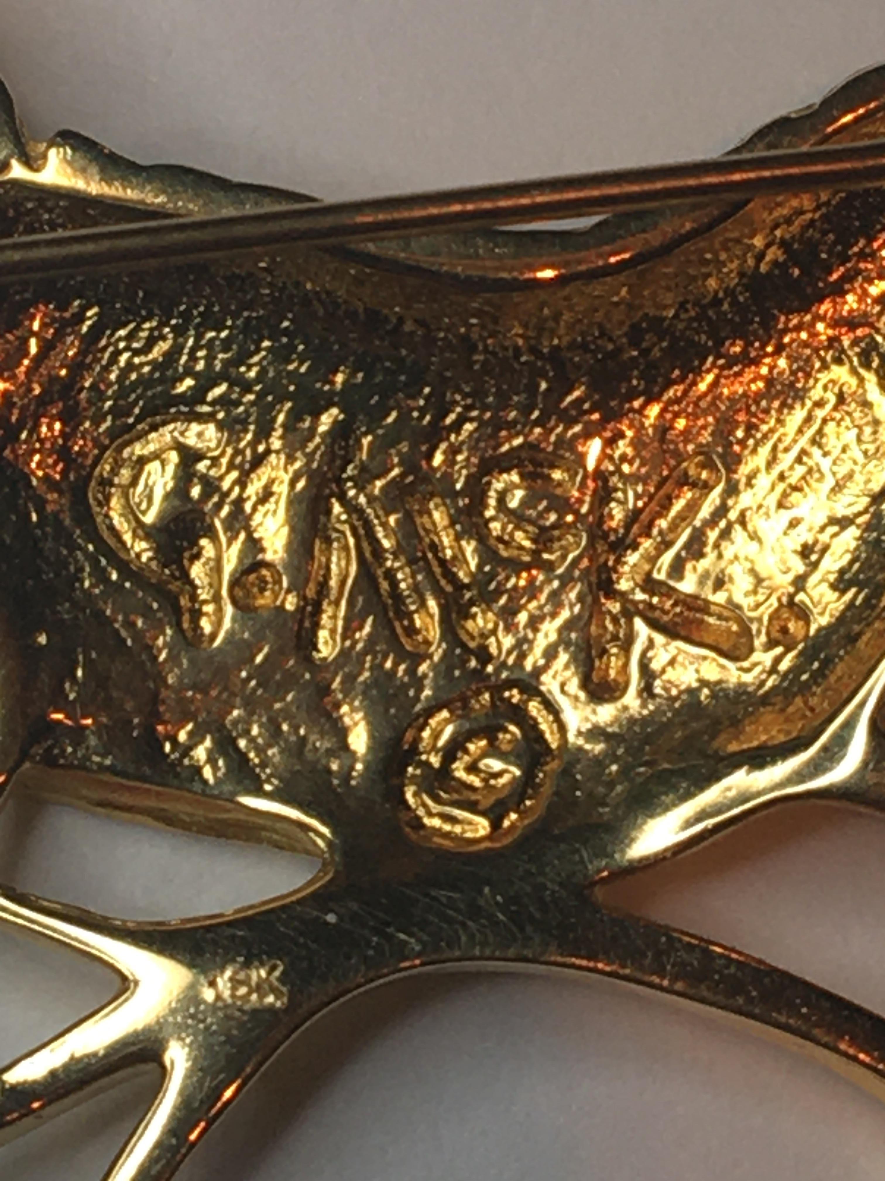 This brooch along, with many others from designer Grainger Mckoy have been displayed at museums across the U.S.  
18 karat yellow gold
Carolina wren bird perched on two 'branches', tail held high.
Stamped  with designer mark 