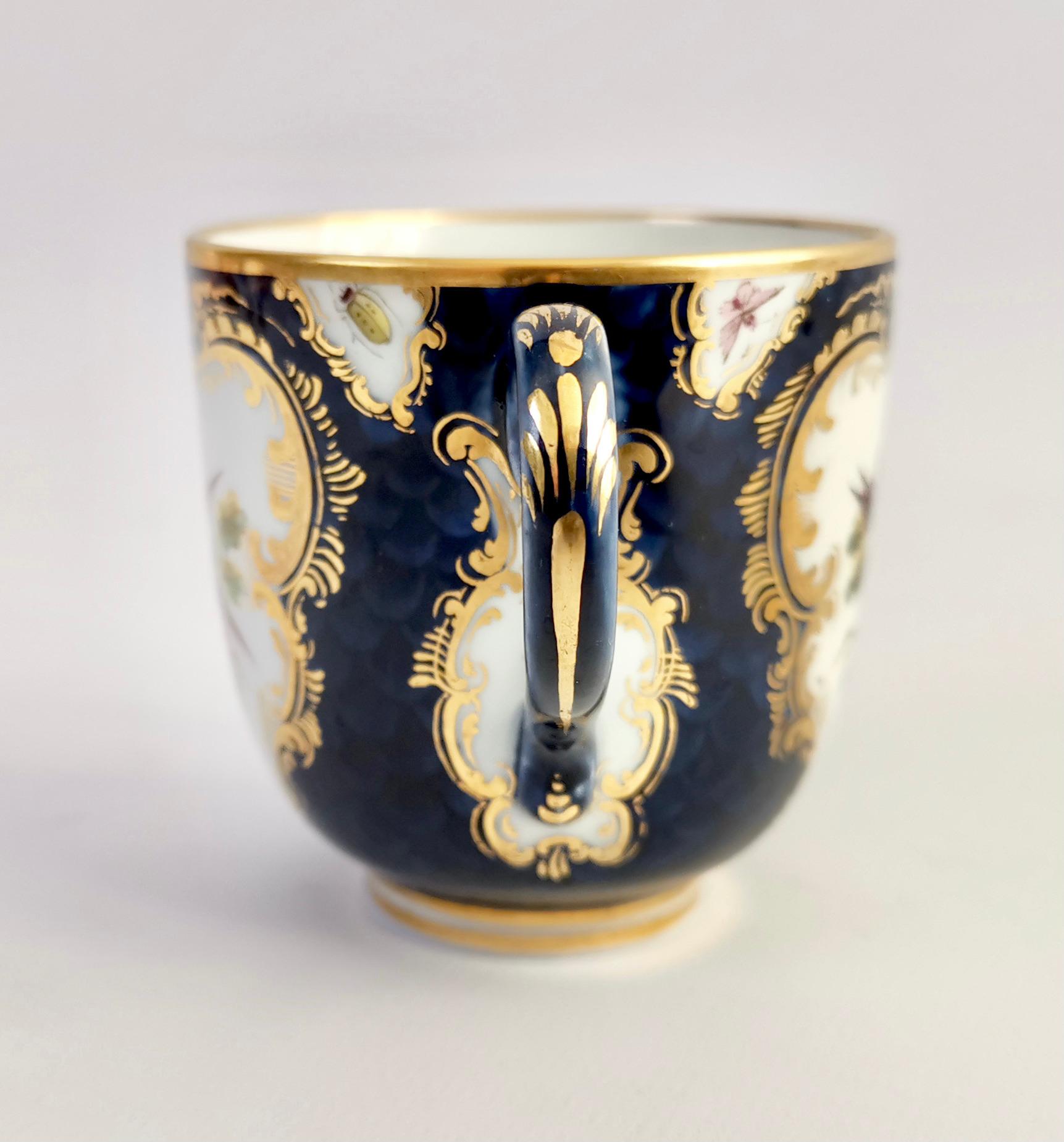 This is a beautiful orphaned coffee cup produced by Grainger & Co in Worcester in 1886, shortly before it merged with the Royal Worcester factory. The cup is decorated in a blue scale ground with Sèvres style birds and bugs.

This little cup would
