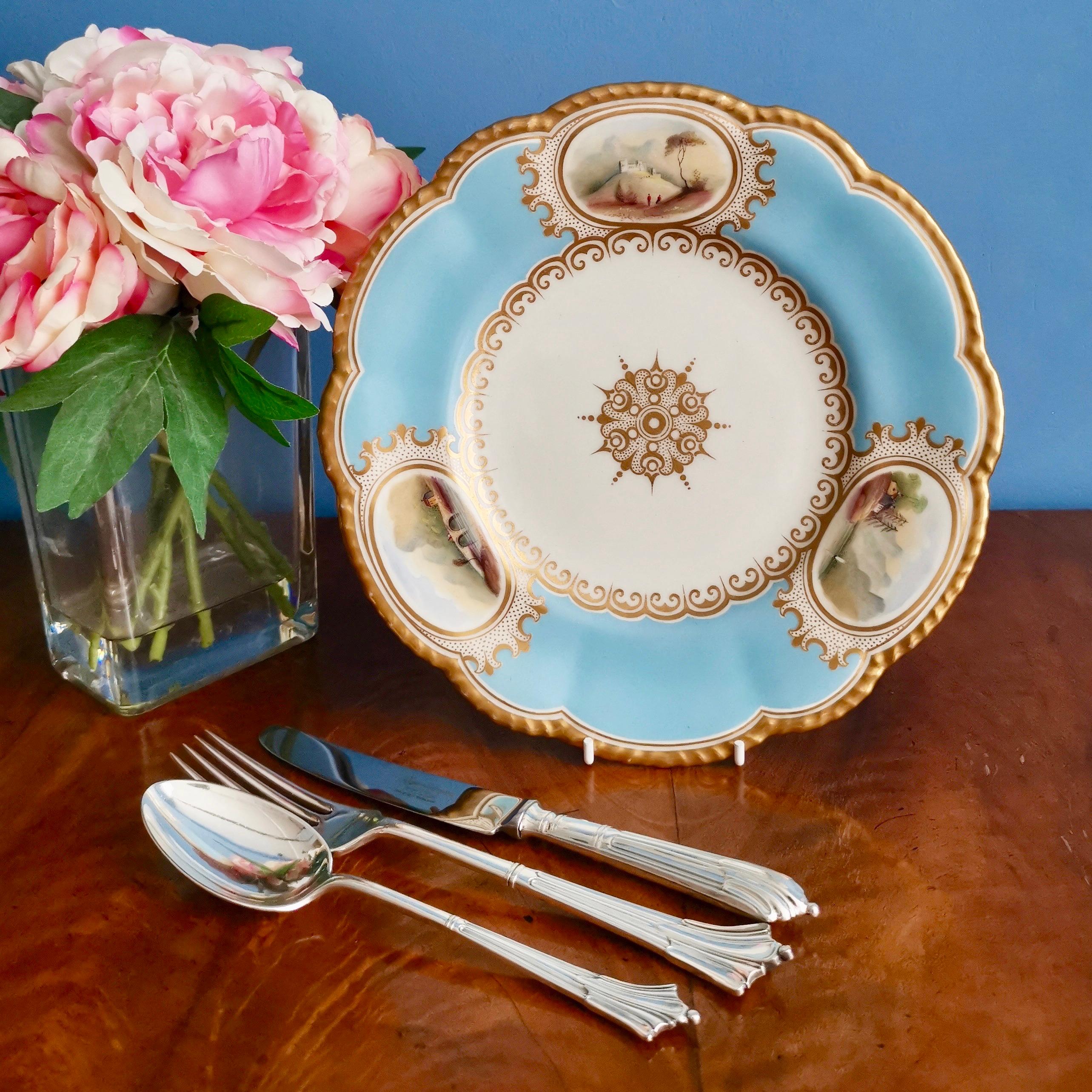 This is a beautiful dessert plate produced by Grainger & Co in Worcester in 1850, which was the Victorian era, circa 1850. The plate is decorated with a sky blue ground, a gilded gadrooned edge and three beautiful hand painted landscapes in white