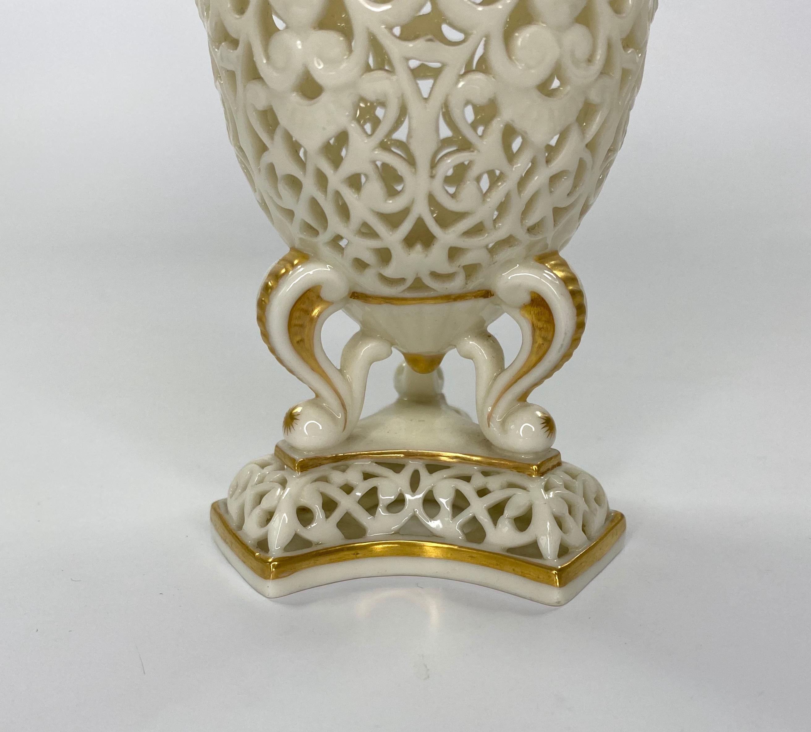 Graingers Royal China Works, Worcester reticulated porcelain vase and cover, c. 1890. The body of the vase, heavily reticulated, with a continuous band of winged angel heads, above profuse scrollwork. Set upon three moulded and gilded scroll feet,