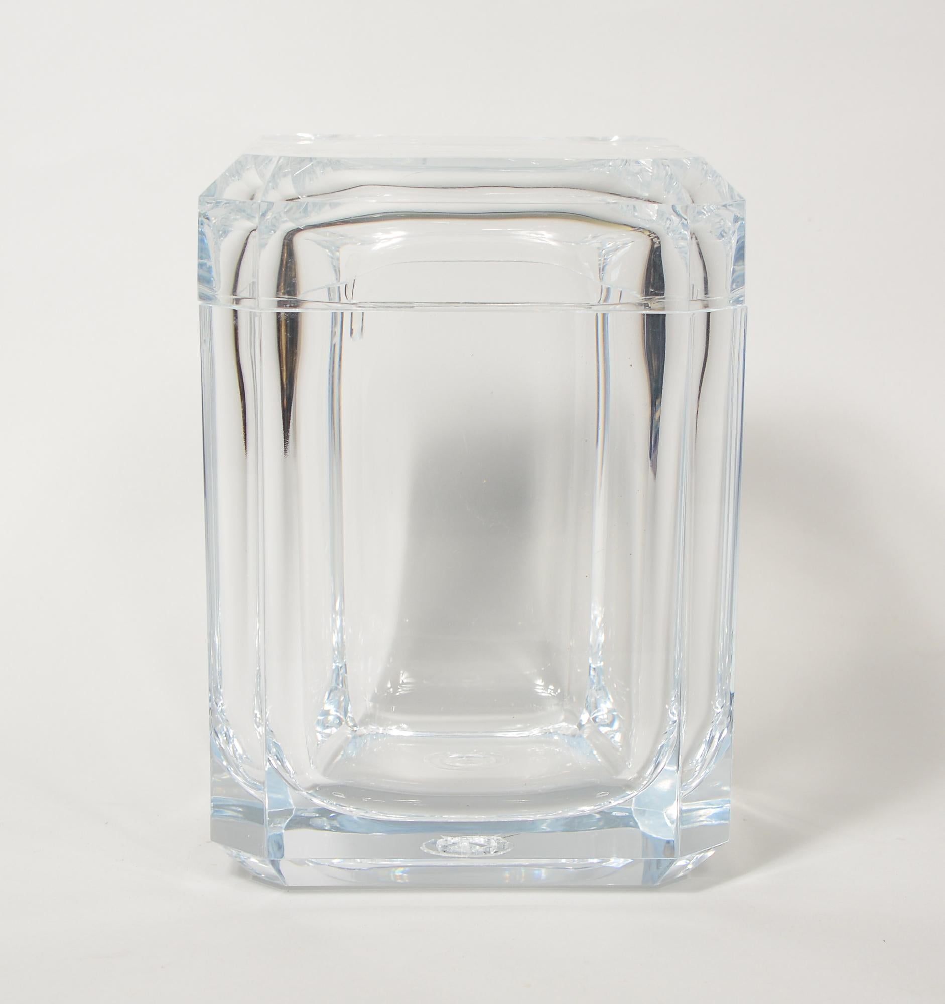 Carlisle acrylic ice bucket by Grainware. This ice bucket has a pivoting top to access the ice. There is some checking in the acrylic in the top and on the bottom center. There may be some small light scratches. 
