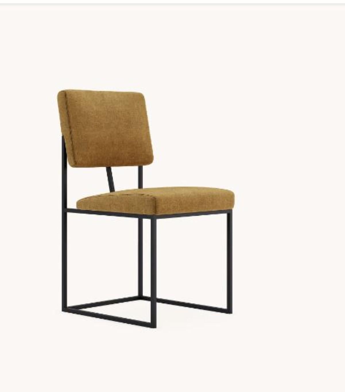 Gram chair by Domkapa
Materials: Fabric, Black Texturized Steel.
Dimensions: W 44 x D 54 x H 86 cm. 
Also available in different materials. 

Eva is the perfect mix of contemporary design and antique production techniques, engraved on the back