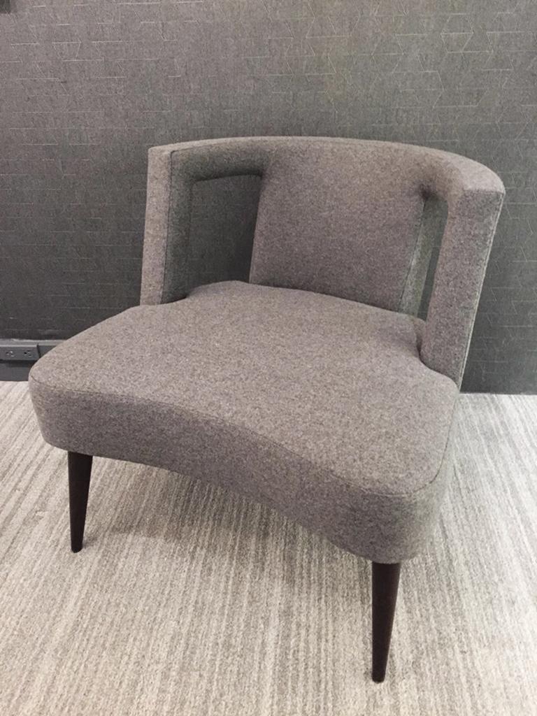 The Gramercy chair has a rounded back with rectangular cutouts. It hugs the thick rounded cushion and stands on Dark Walnut cone shaped legs. Shown here in Grey upholstery. 

CF Modern merchandise is available in custom sizes, wood and hardware