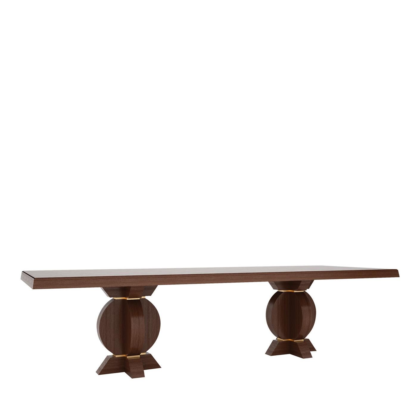 Distinguished by an imposing and timeless silhouette, this dining table is crafted of solid, high-quality wood, which is available in other finishes and colors. The two legs supporting the flat rectangular top showcase an intriguing intersection of