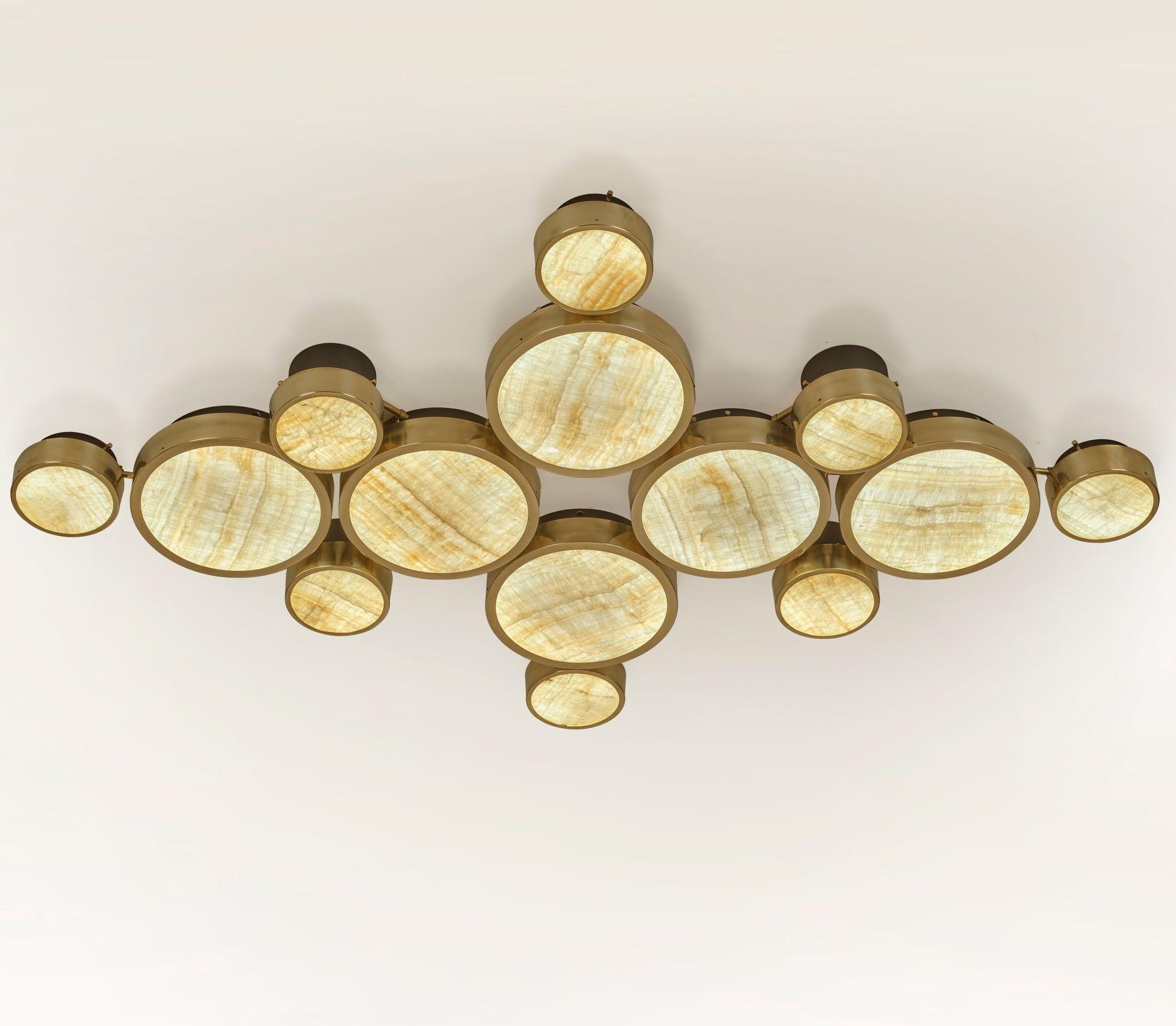 Gran Costellazione is a modular collection that combines lighting elements of varying diameters and heights, resulting in a graphic, sculptural composition and a refined light output. It features a mid-century influence with contemporary