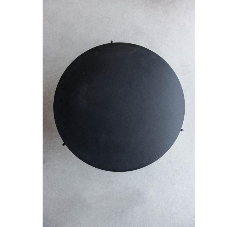 The Granada Round Coffee Table is a refined living space centerpiece. Its Absolute Black Granite top provides a subtle, monochromatic element to the design, while the simple and sleek matte black steel base allows the top to take center stage. The