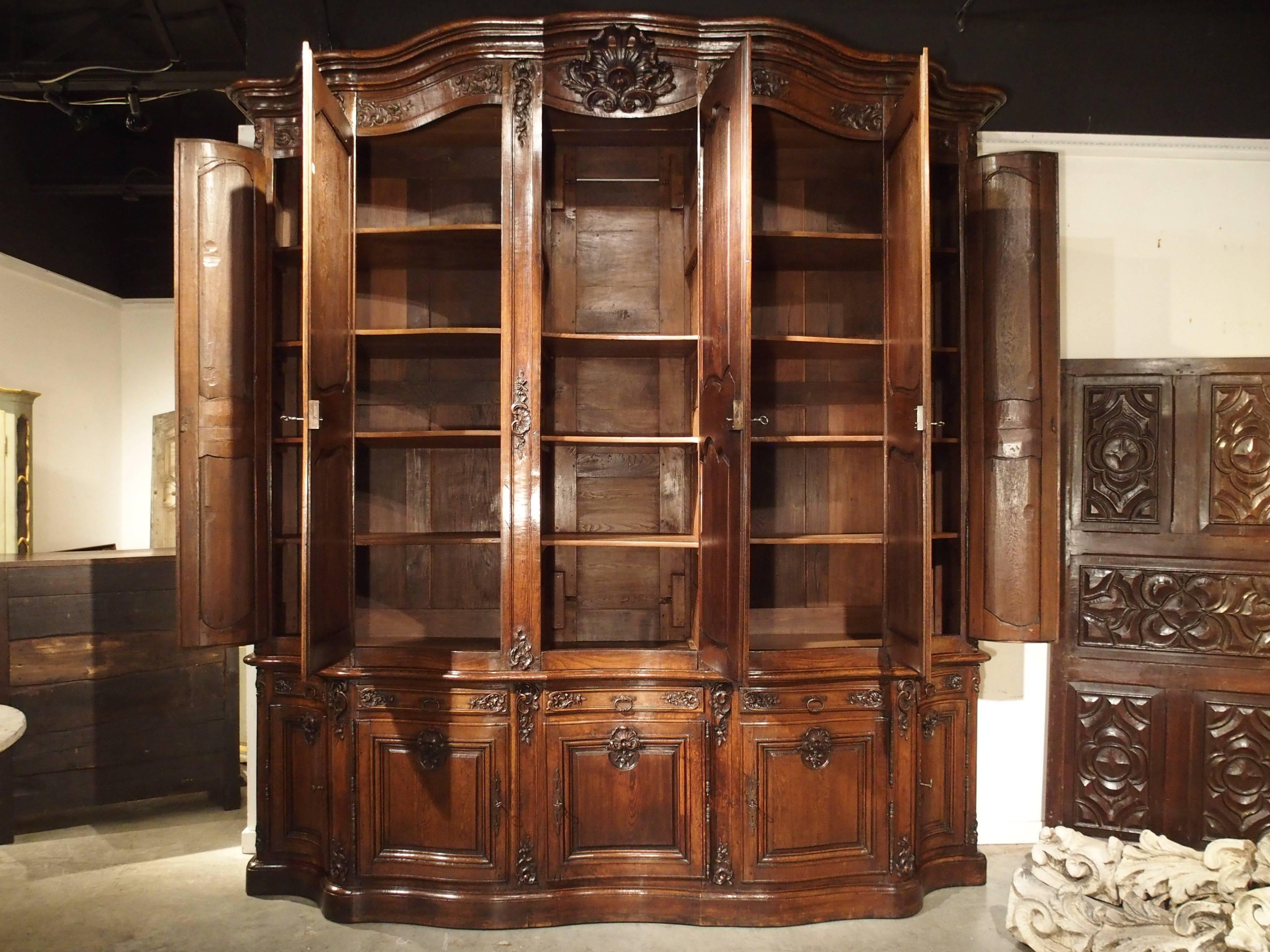 This magnificent and rare period French Regence (1715-1723) buffet is made from French oak. It is referred to in France as a buffet deux corps (2 bodied buffet, upper and lower), and also a buffet de presentation. This large piece was used to house