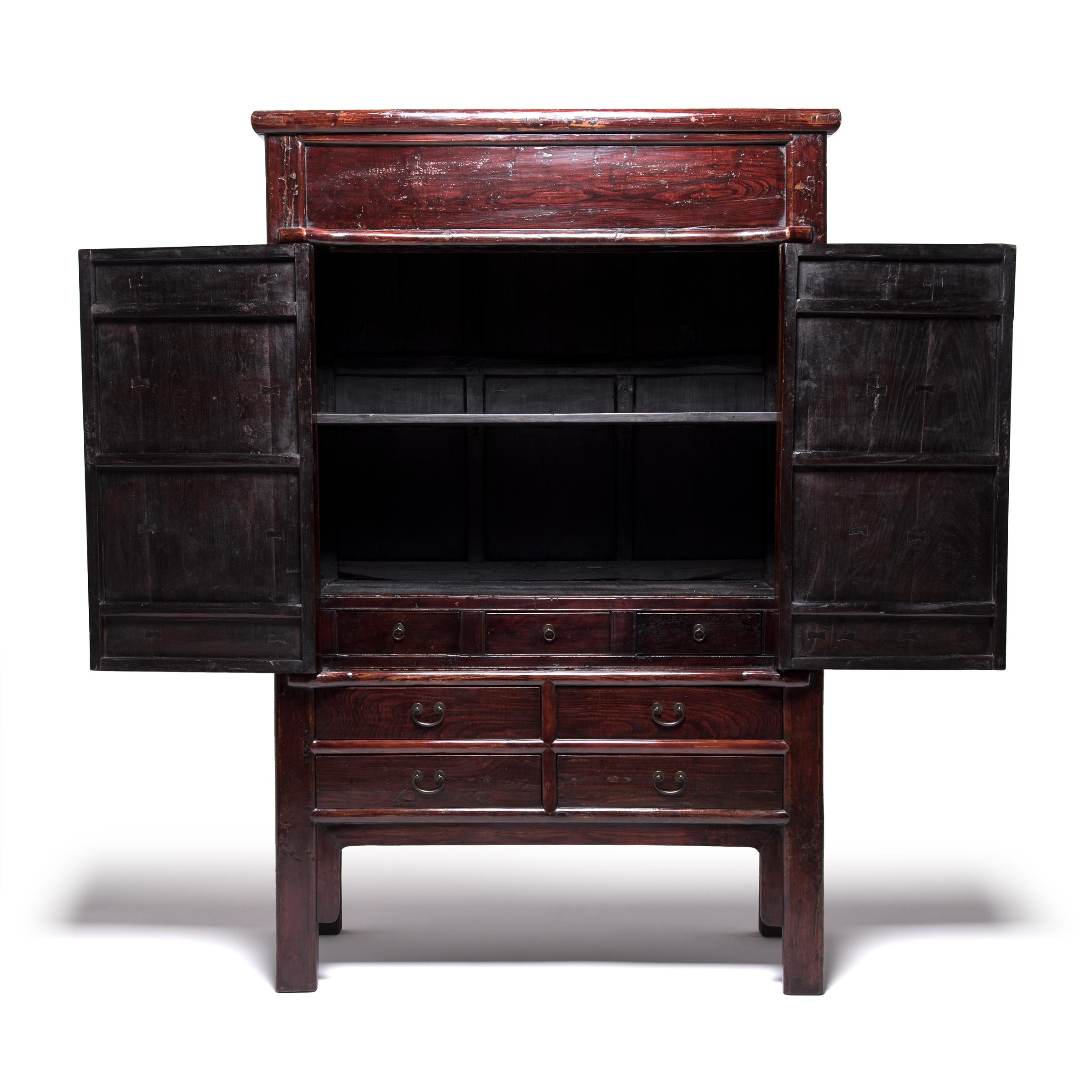 This austere 19th century Chinese cabinet from China's Shanxi province was constructed with grand proportions. The expressive grain of northern elmwood (yumu) patterns the doors with subtle texture and adds an understated elegance to a cabinet of