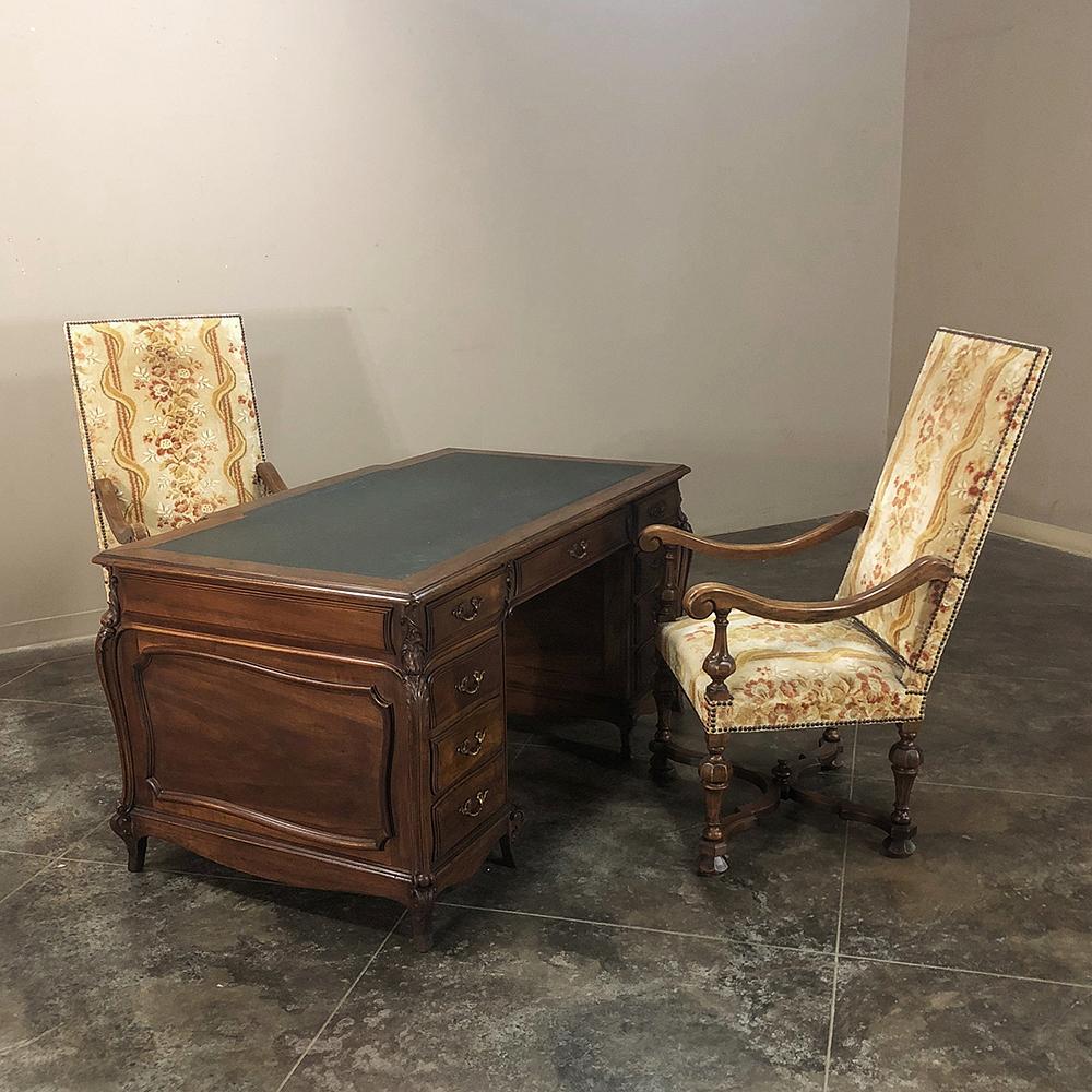 Grand 19th century French Louis XIV walnut partner's desk will make an executive's office the talk of the company! Featuring boldly scrolled cornerposts set at 45 degree angles all around, it is finished on all four sides for placement in the center