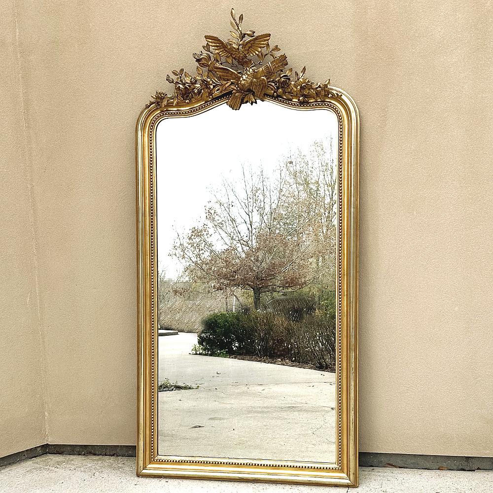 Grand 19th Century French Louis XVI Gilded Mirror ist ein Meisterwerk der Bildhauerkunst!  Durch seine Größe ist der Spiegel ideal für hohe Decken oder als Bodenspiegel geeignet.  Der untere, linke und rechte Rahmen hat ein maßgeschneidertes Design,